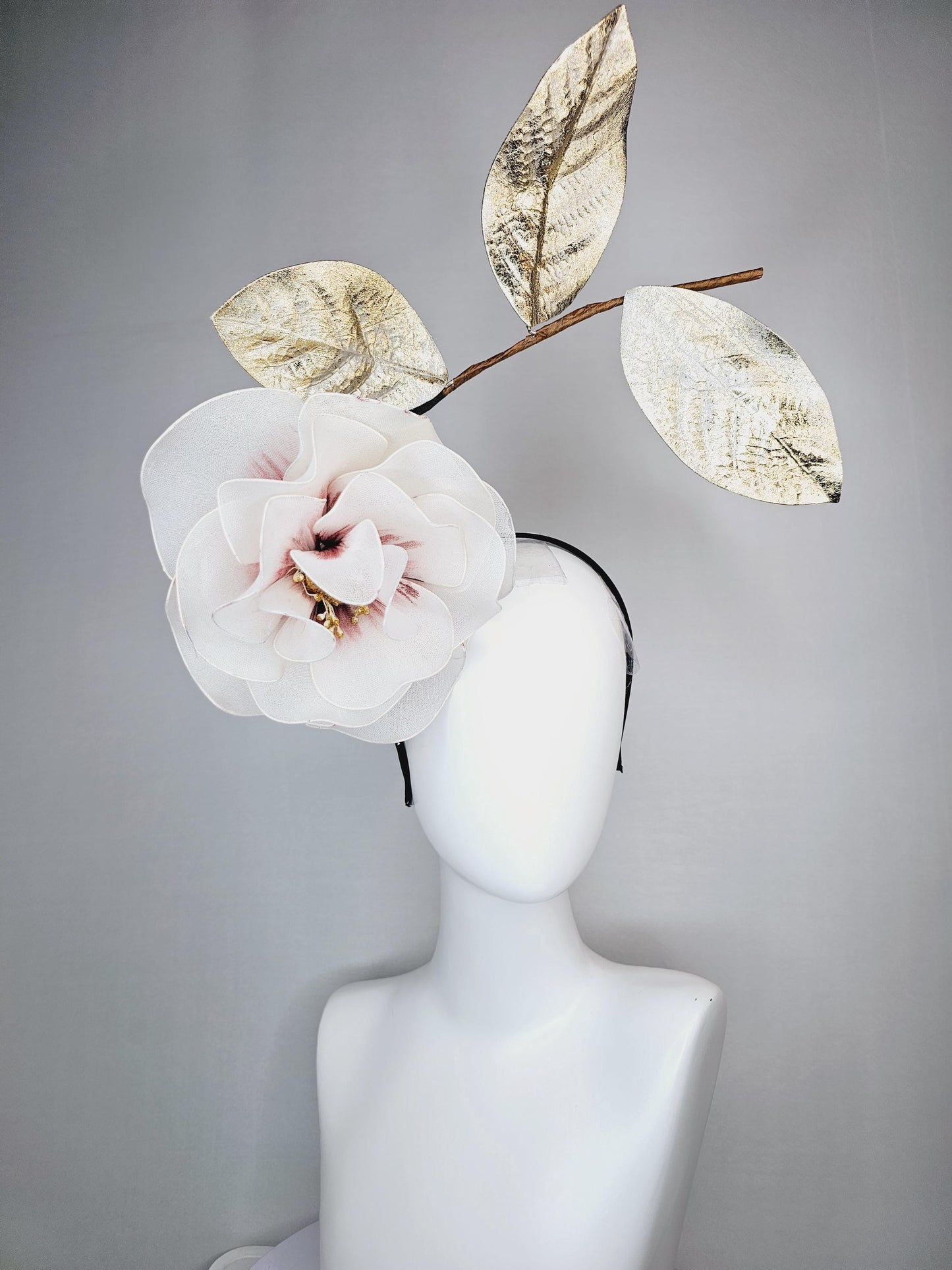 kentucky derby hat fascinator headband with large ivory white wire mesh flower on stem with large gold leaves