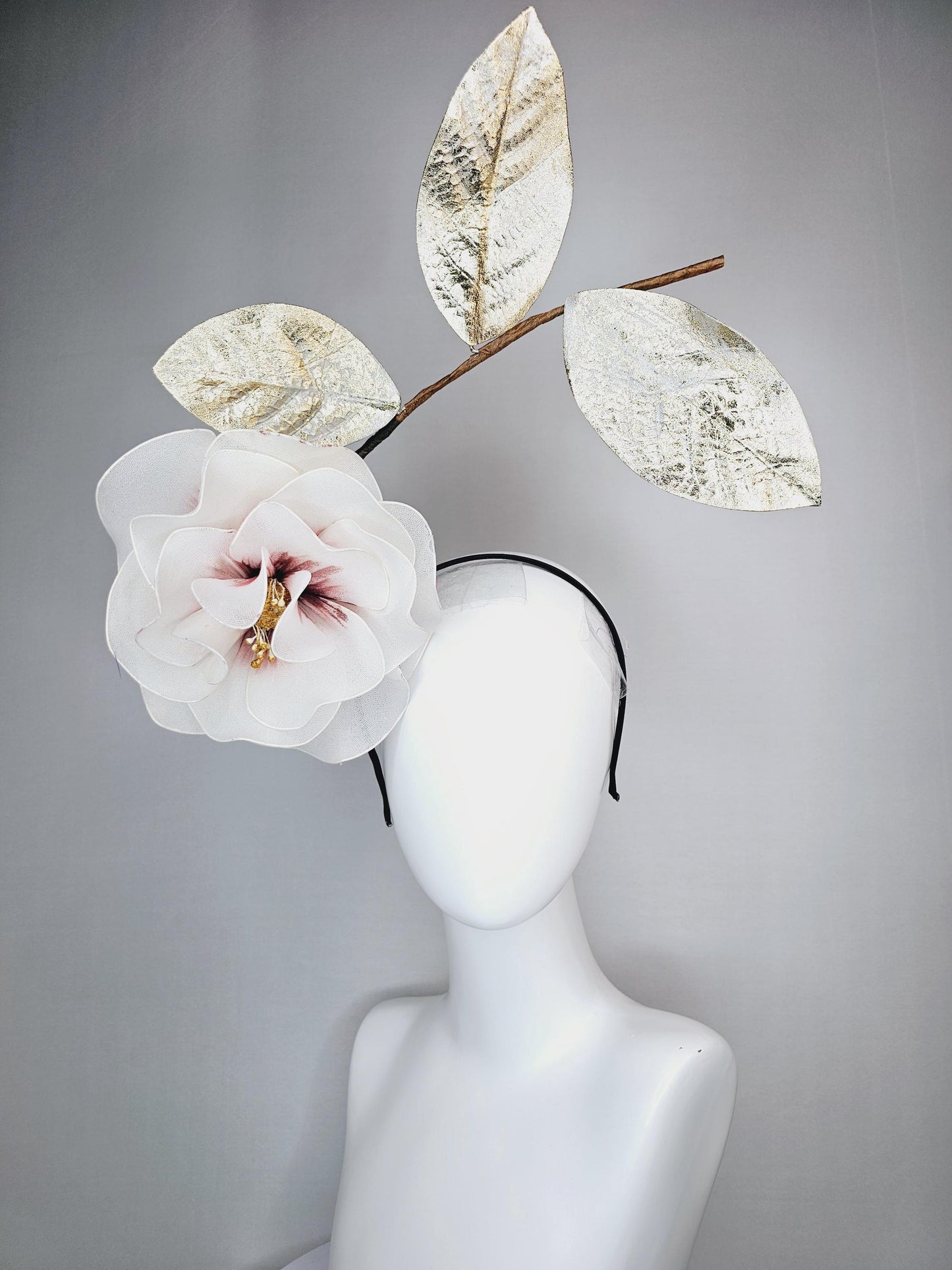 kentucky derby hat fascinator headband with large ivory white wire mesh flower on stem with large gold leaves