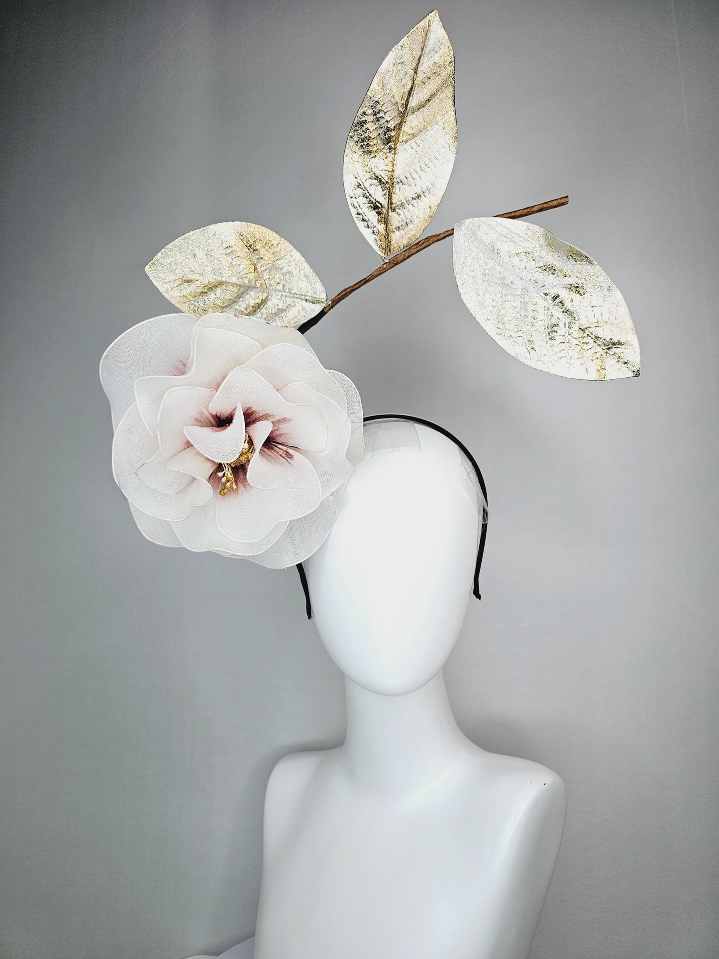 kentucky derby hat fascinator headband with large ivory white wire mesh flower on stem with large gold leaves