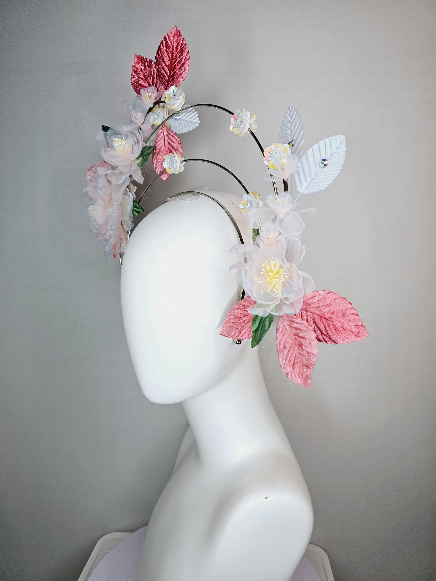 kentucky derby hat fascinator light pink and blue organza flowers dusty pink green leaves on tiered silver metallic headband sequin flower