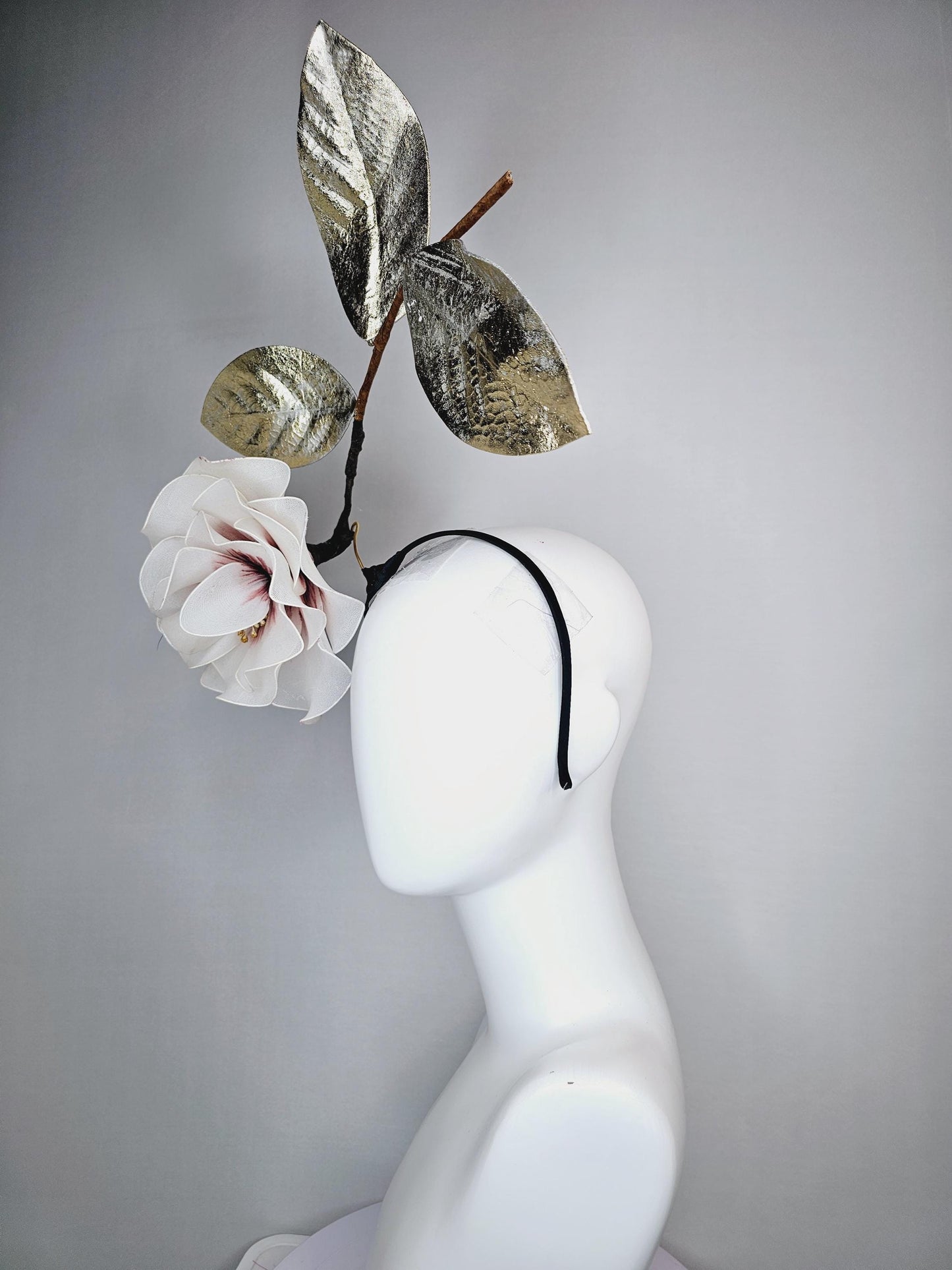 kentucky derby hat fascinator headband with large ivory white wire mesh flower on stem with large gold leaves
