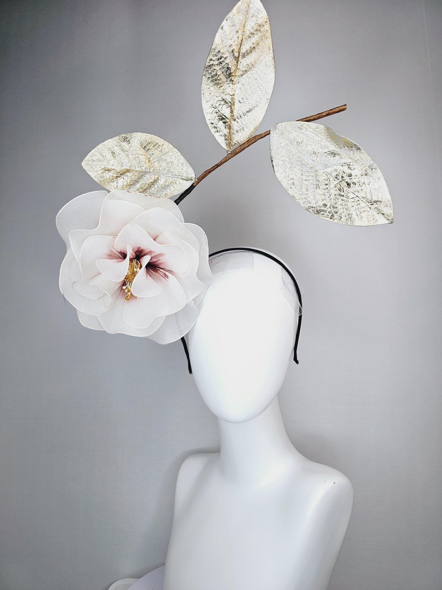 kentucky derby hat fascinator headband with large ivory white wire mesh flower on stem with large gold leaves