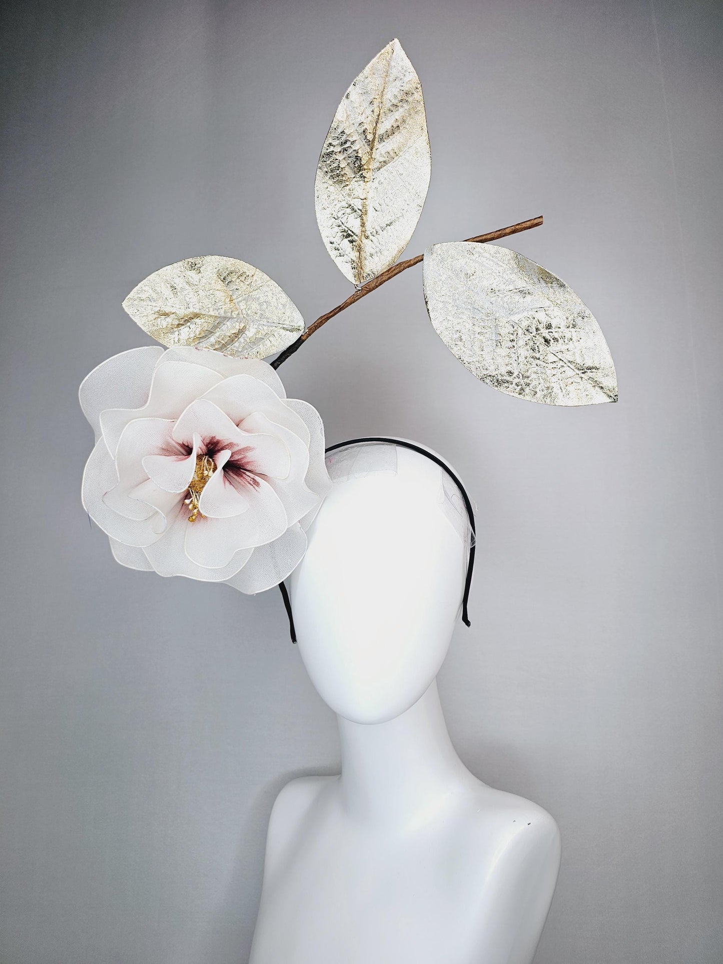 kentucky derby hat fascinator headband with large ivory white wire mesh flower on stem with large gold leaves
