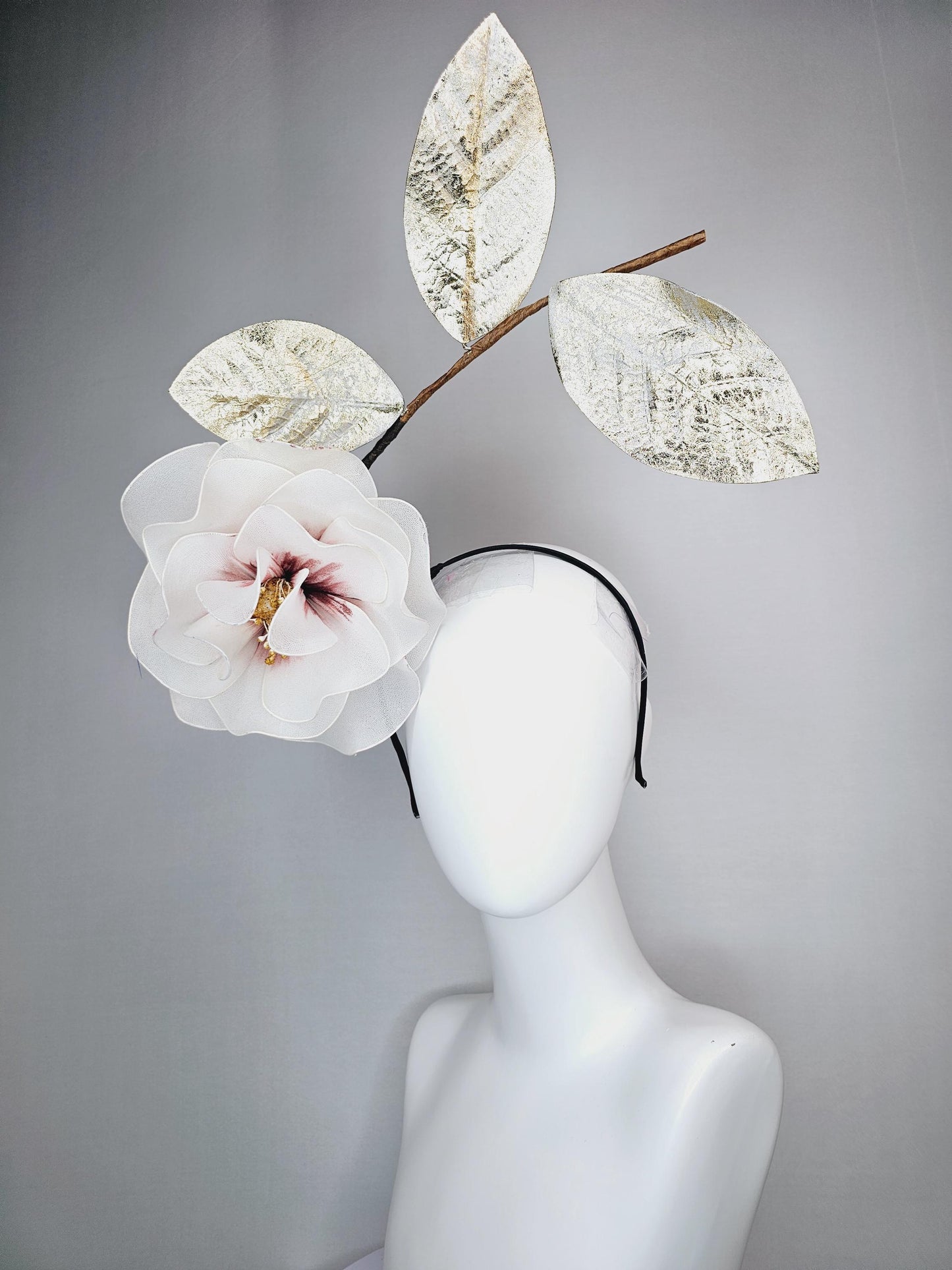 kentucky derby hat fascinator headband with large ivory white wire mesh flower on stem with large gold leaves