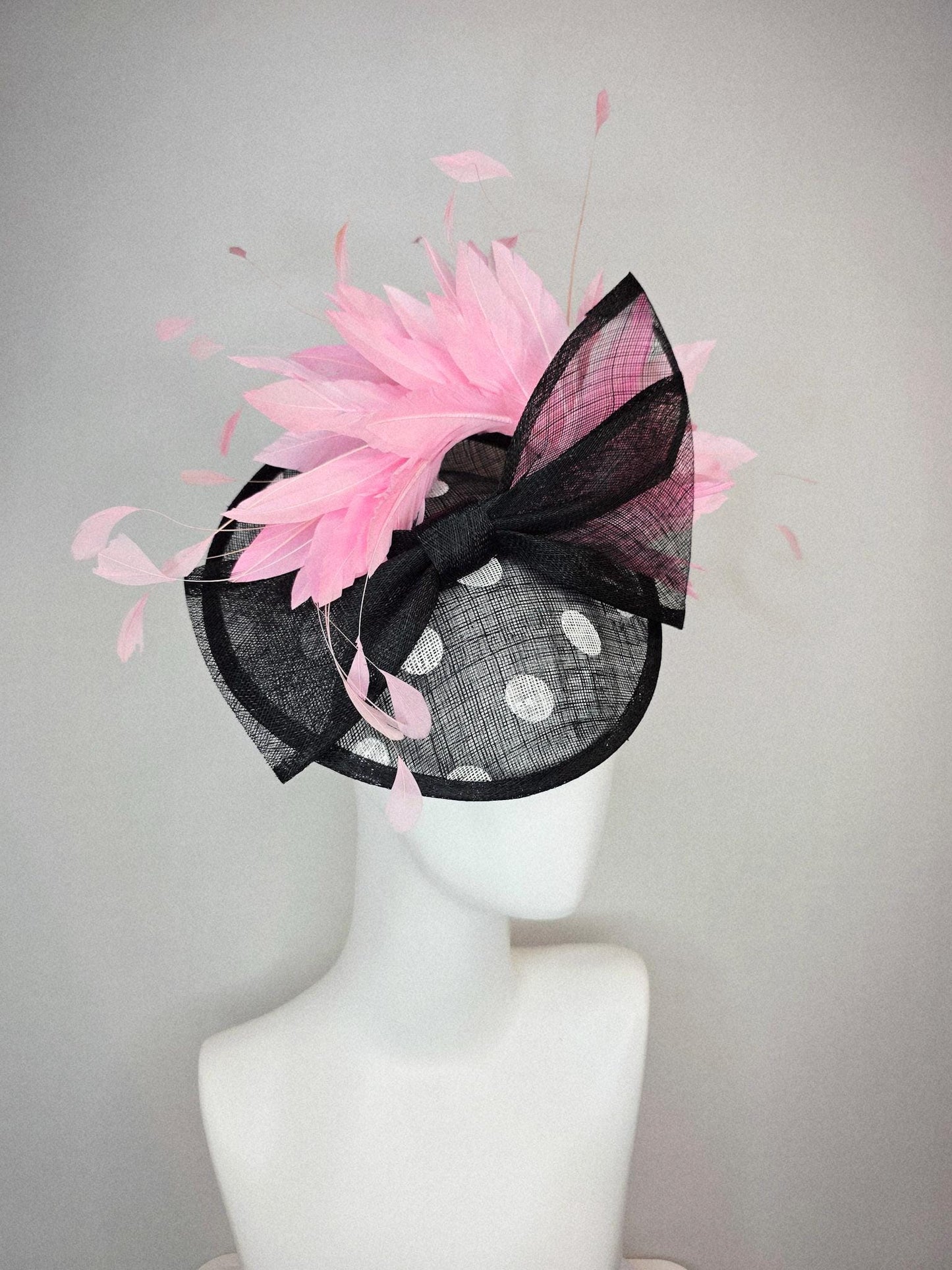 kentucky derby hat fascinator black and white polka dot sinamay saucer with black sinamay bow and light baby pink branching feathers