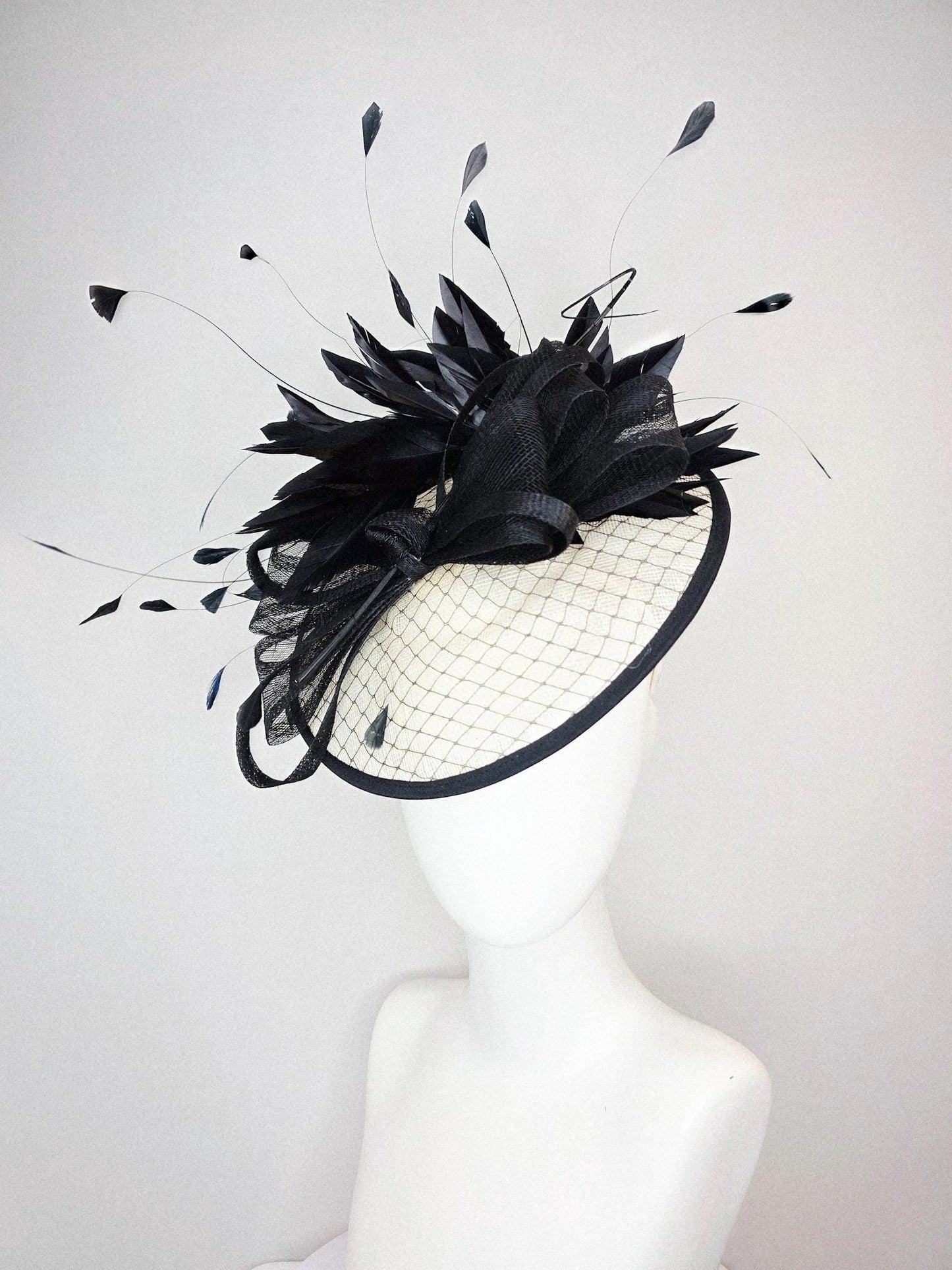 kentucky derby hat fascinator ivory white sinamay saucer with black netting and black sinamay trim and bow and black branching feathers
