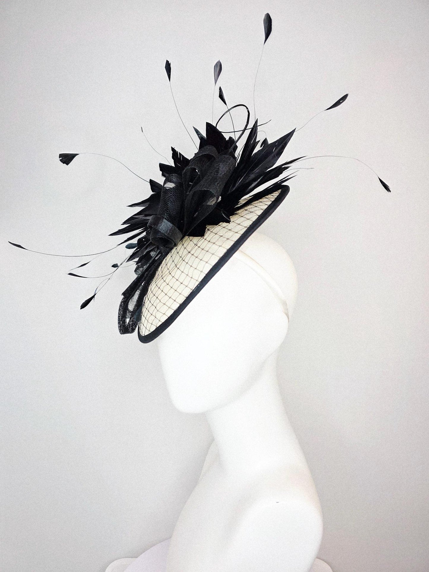 kentucky derby hat fascinator ivory white sinamay saucer with black netting and black sinamay trim and bow and black branching feathers