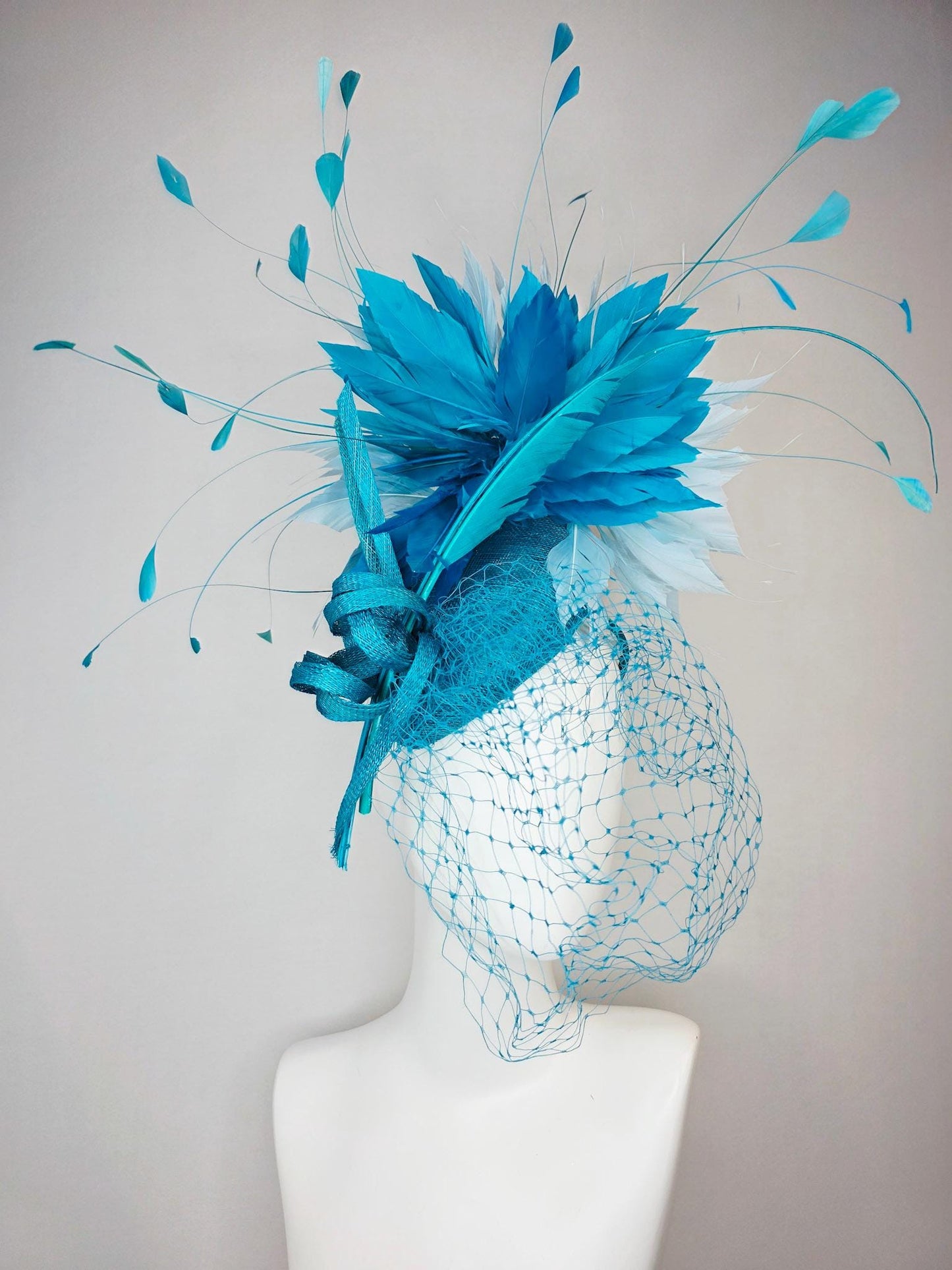 kentucky derby hat fascinator sky blue sinamay with sinamay bow and sky teal and light blue feathers and blue mesh veil