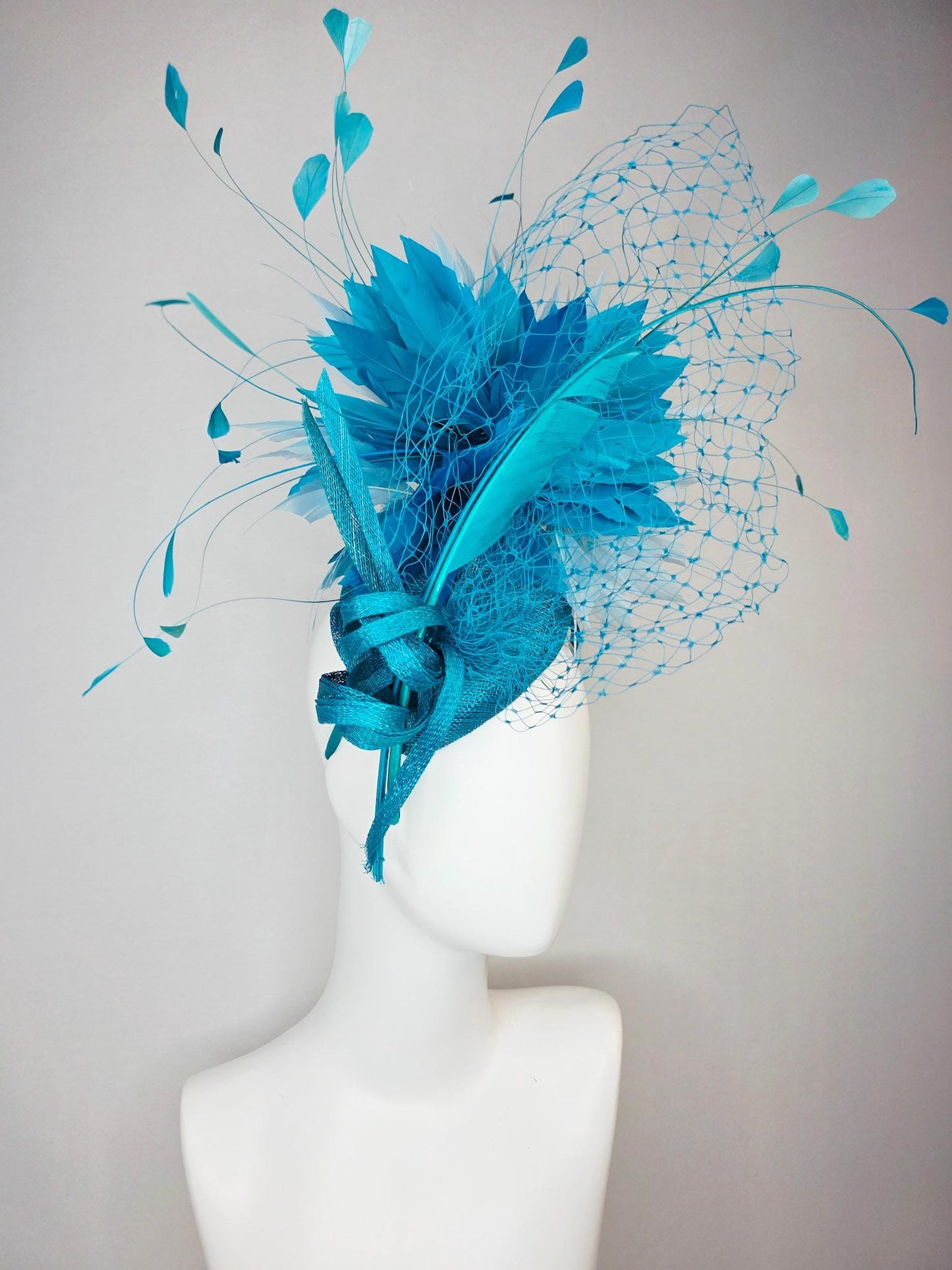 kentucky derby hat fascinator sky blue sinamay with sinamay bow and sky teal and light blue feathers and blue mesh veil