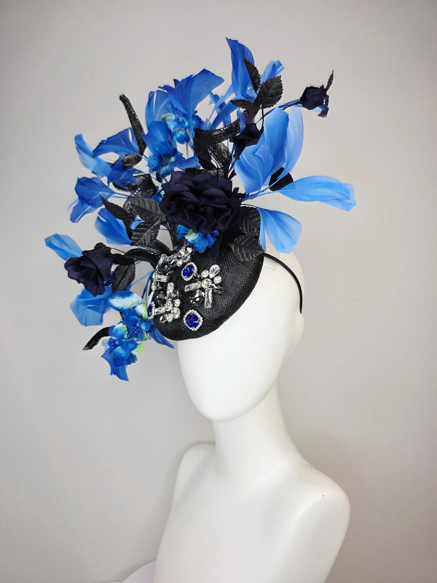 kentucky derby hat fascinator black sinamay with curls blue and clear crystal jewels navy blue satin roses black leaves royal blue feathers