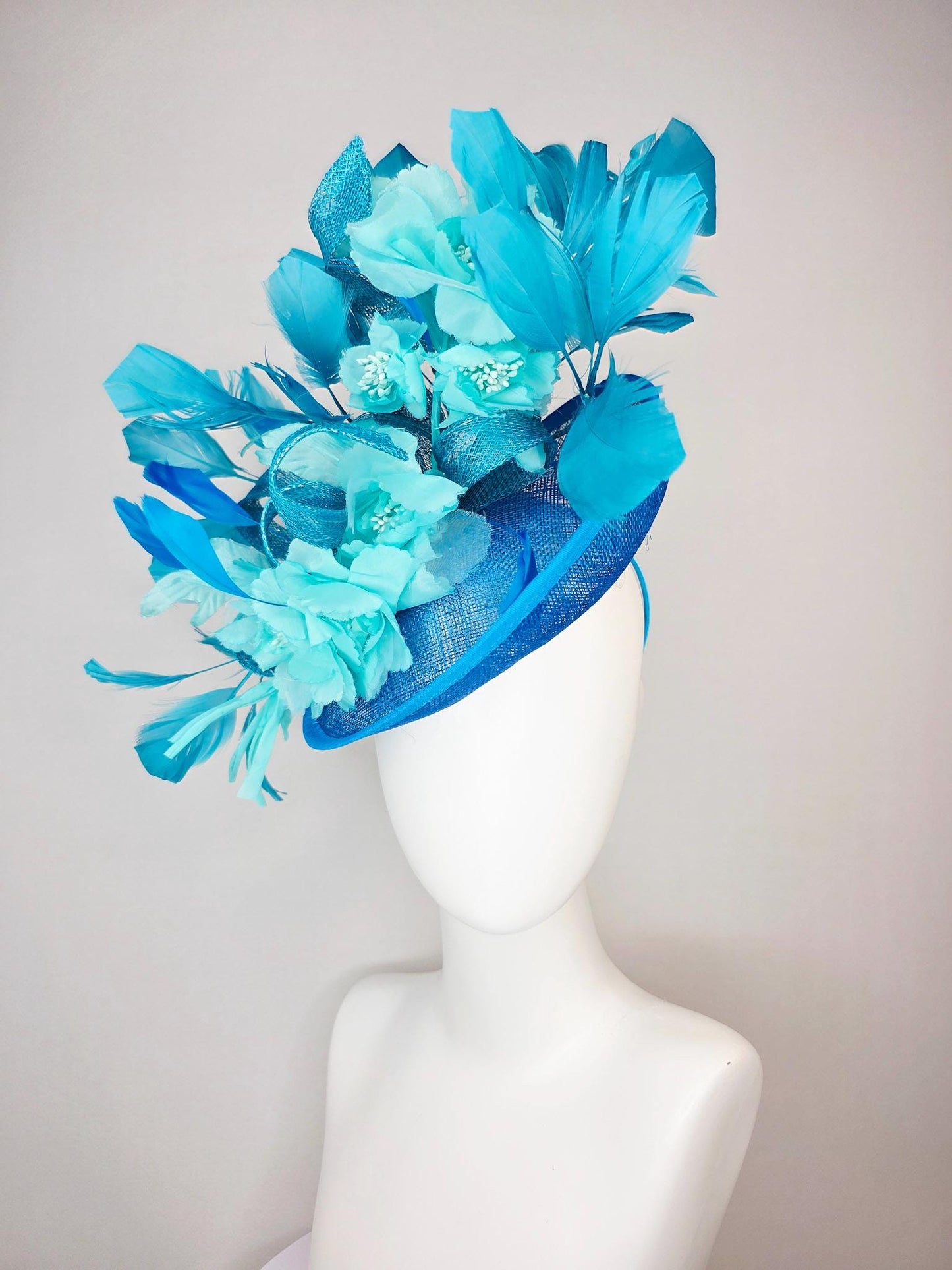 kentucky derby hat fascinator turquoise blue sinamay saucer with bow aqua blue organza satin flowers sky and royal blue branching feathers