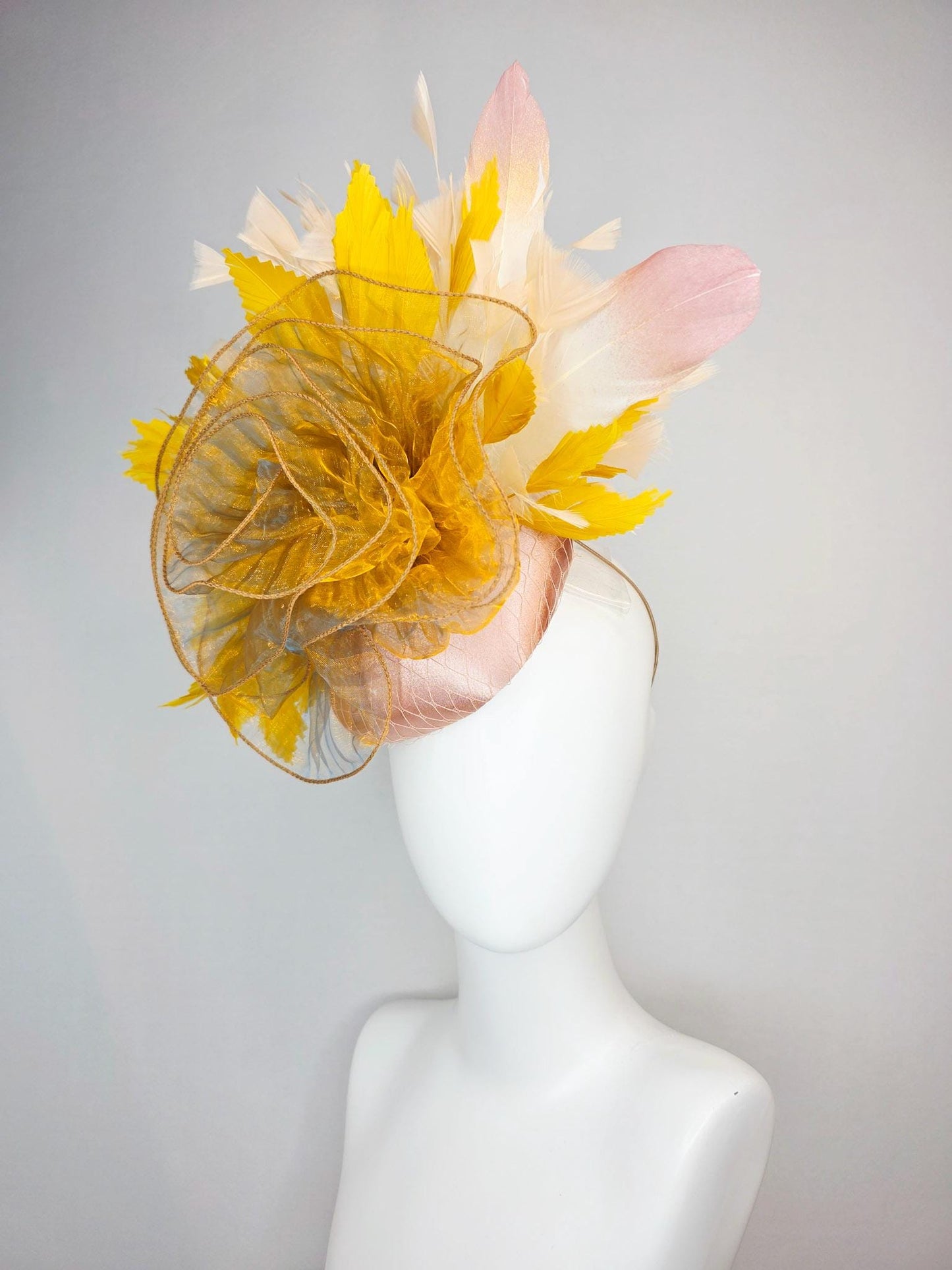 kentucky derby hat fascinator champagne pink satin with netting with large gold organza flower and mustard yellow cream beige feathers