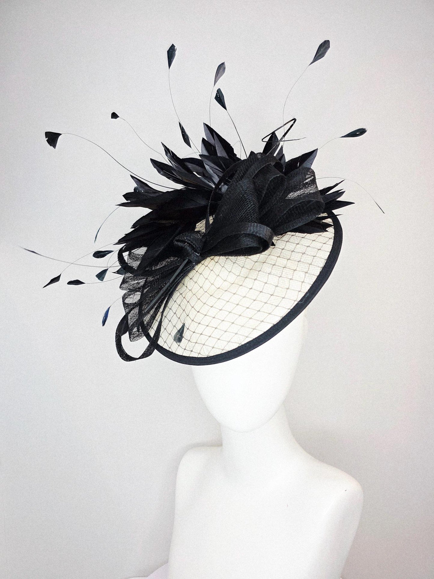 kentucky derby hat fascinator ivory white sinamay saucer with black netting and black sinamay trim and bow and black branching feathers