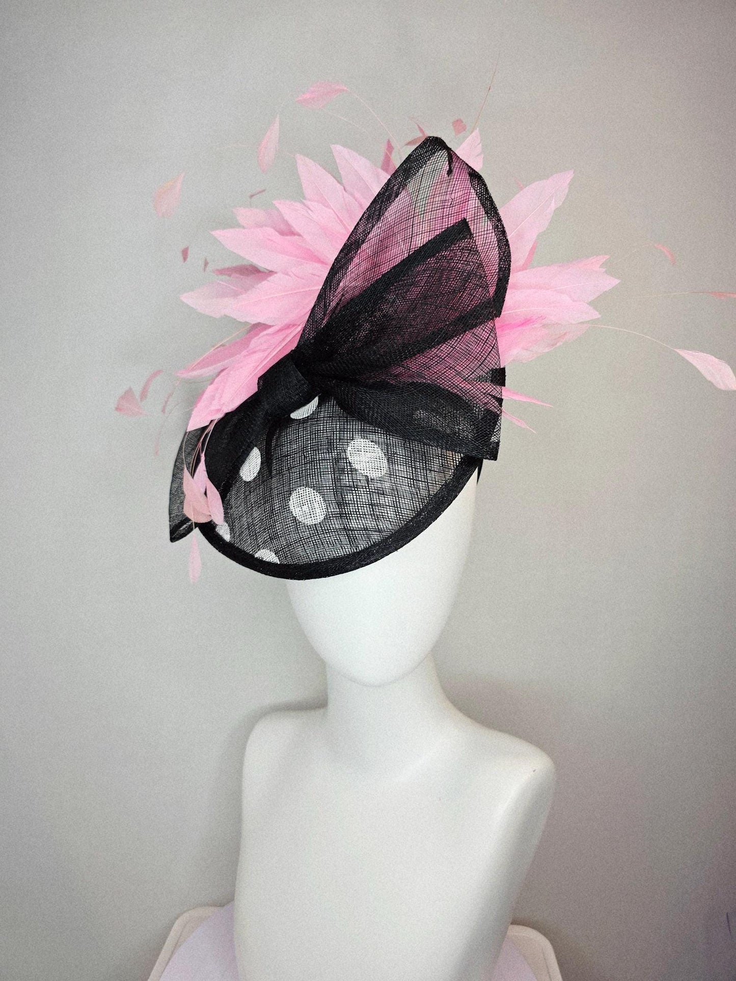 kentucky derby hat fascinator black and white polka dot sinamay saucer with black sinamay bow and light baby pink branching feathers
