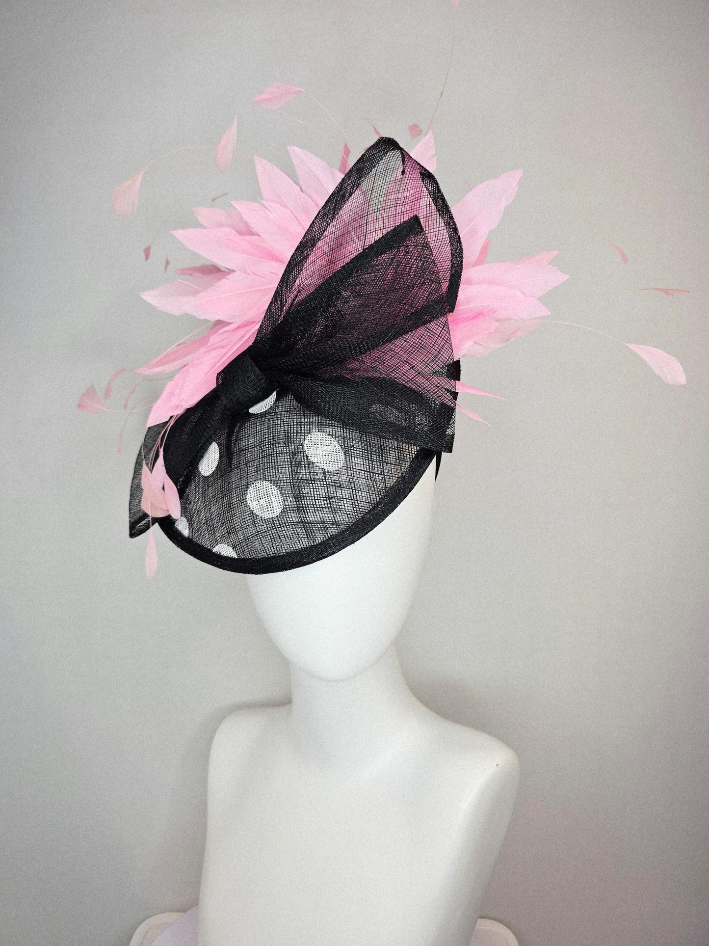 kentucky derby hat fascinator black and white polka dot sinamay saucer with black sinamay bow and light baby pink branching feathers