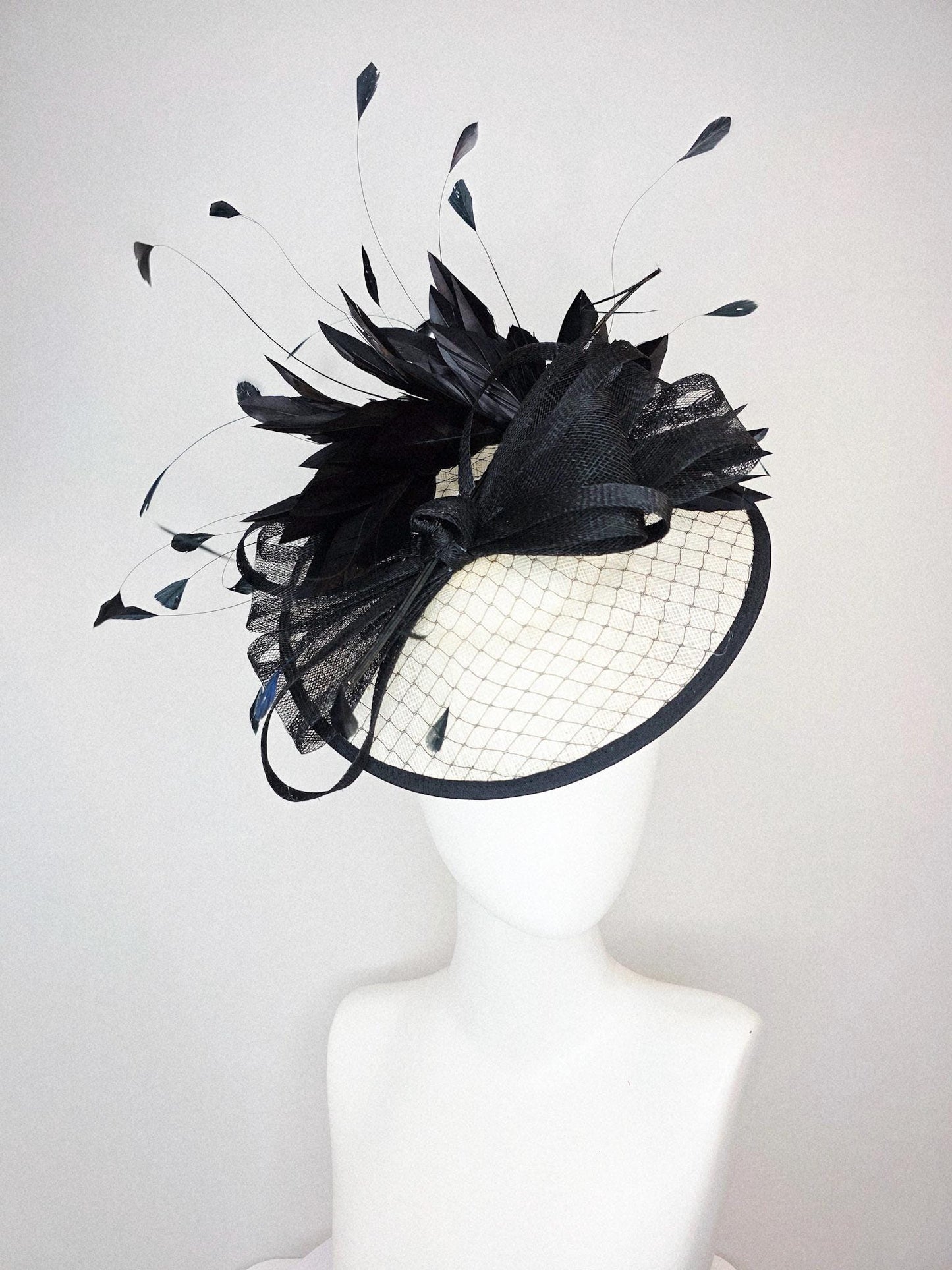 kentucky derby hat fascinator ivory white sinamay saucer with black netting and black sinamay trim and bow and black branching feathers