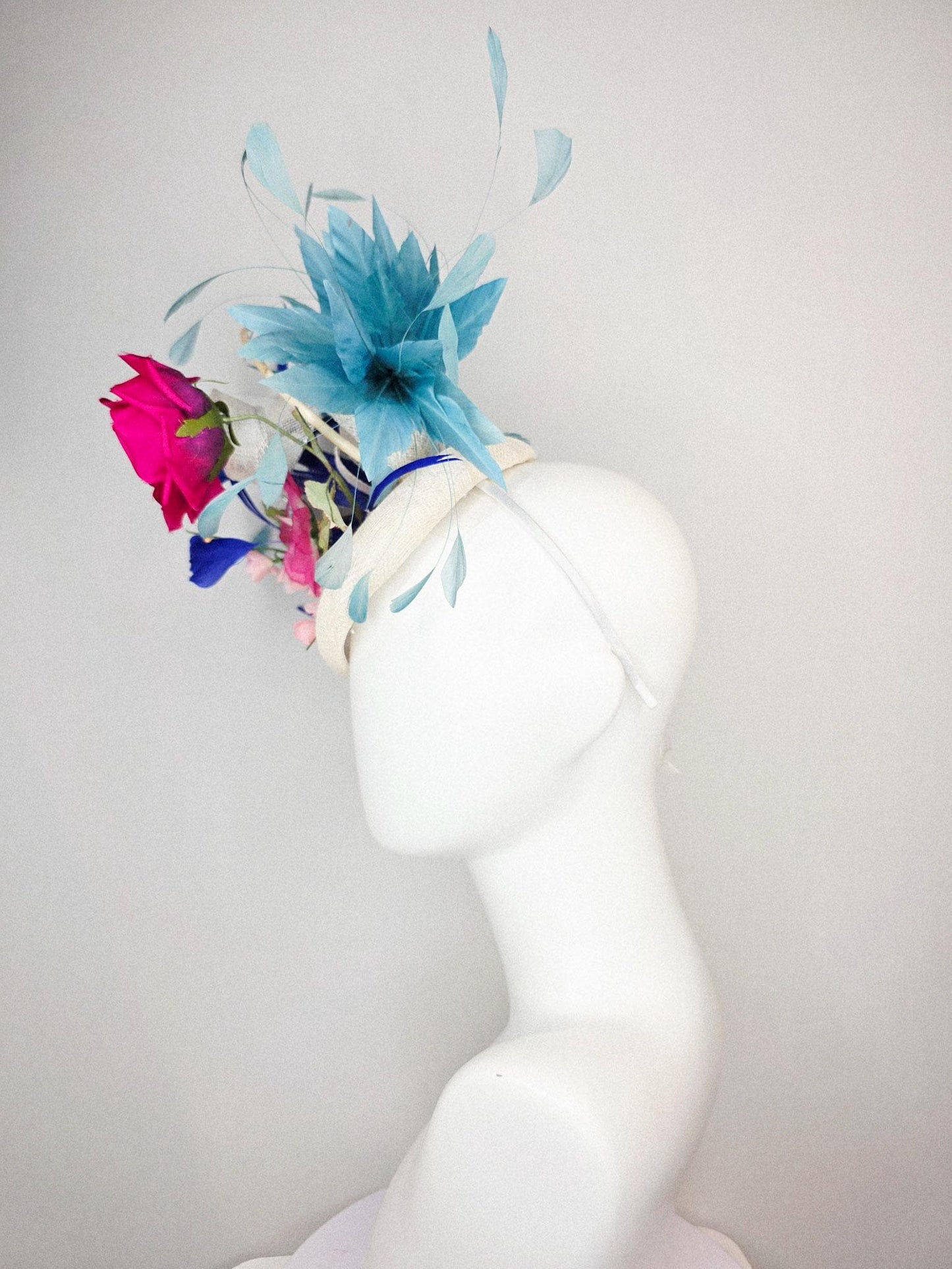 kentucky derby hat fascinator white sinamay with curls fuchsia satin rose and pink flowers light green leaves and cobalt teal blue feathers