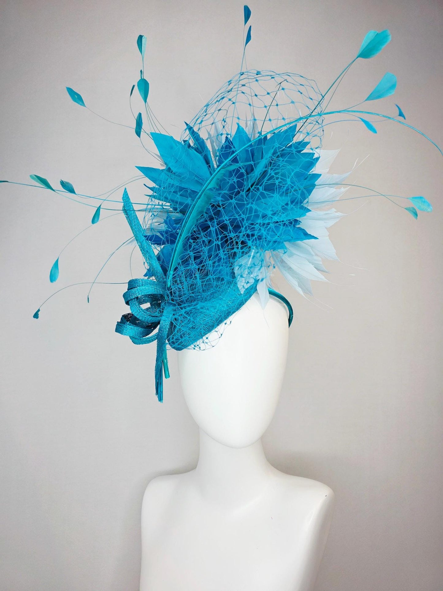 kentucky derby hat fascinator sky blue sinamay with sinamay bow and sky teal and light blue feathers and blue mesh veil