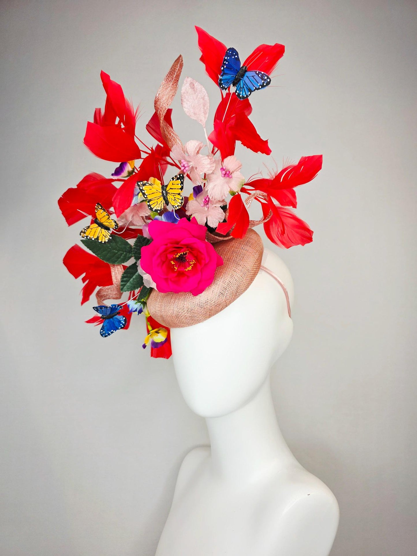 kentucky derby hat fascinator champagne pink sinamay fuchsia satin rose light pink flowers green leaves red feathers blue yellow butterflies