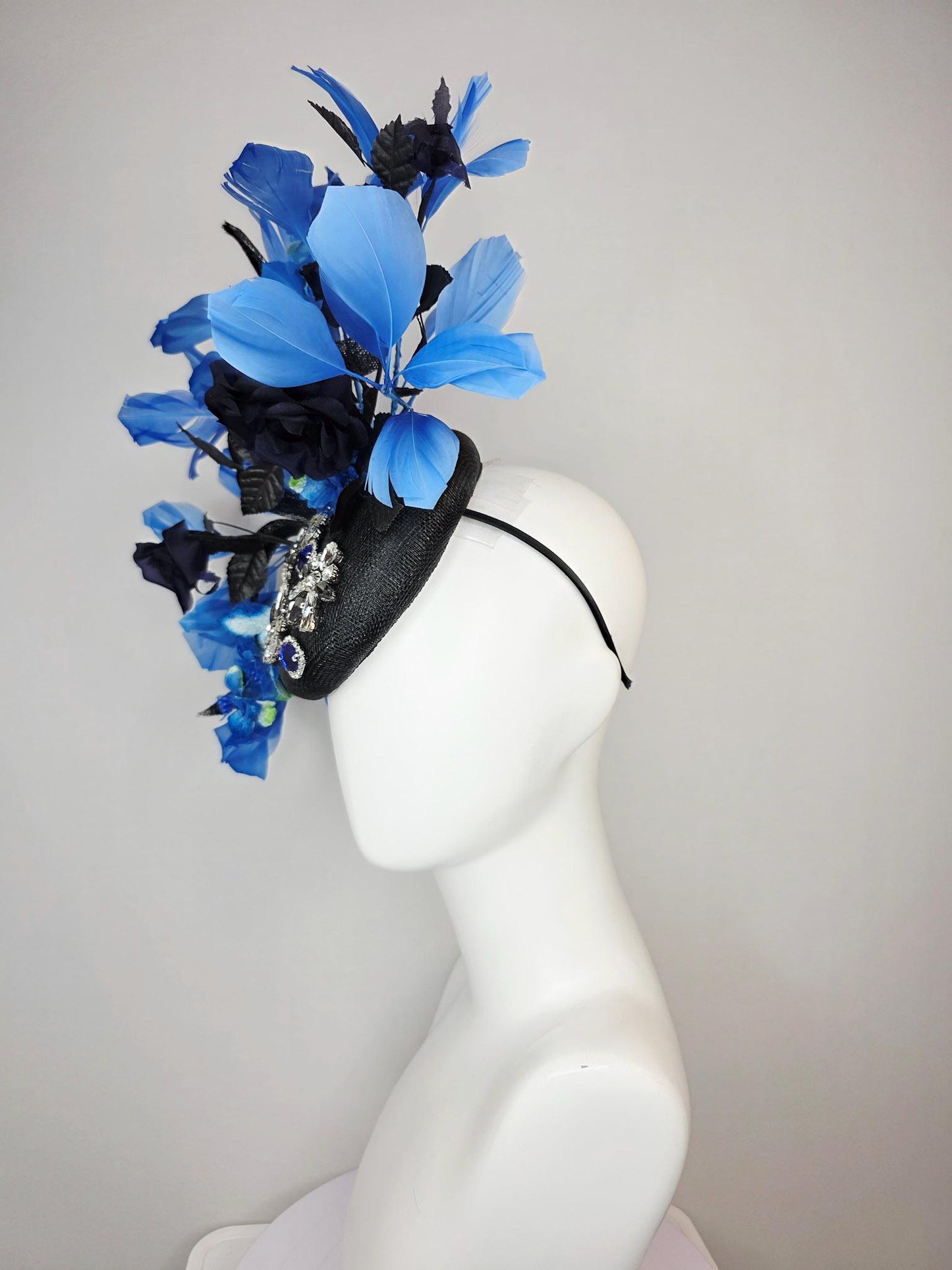 kentucky derby hat fascinator black sinamay with curls blue and clear crystal jewels navy blue satin roses black leaves royal blue feathers