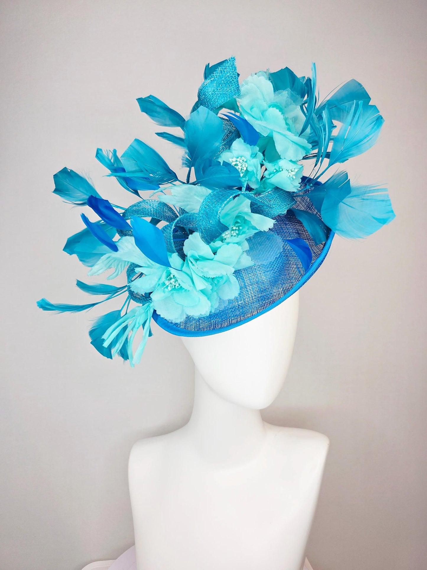 kentucky derby hat fascinator turquoise blue sinamay saucer with bow aqua blue organza satin flowers sky and royal blue branching feathers