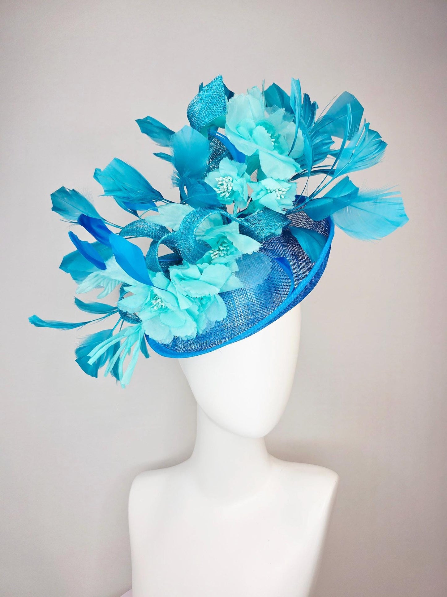 kentucky derby hat fascinator turquoise blue sinamay saucer with bow aqua blue organza satin flowers sky and royal blue branching feathers