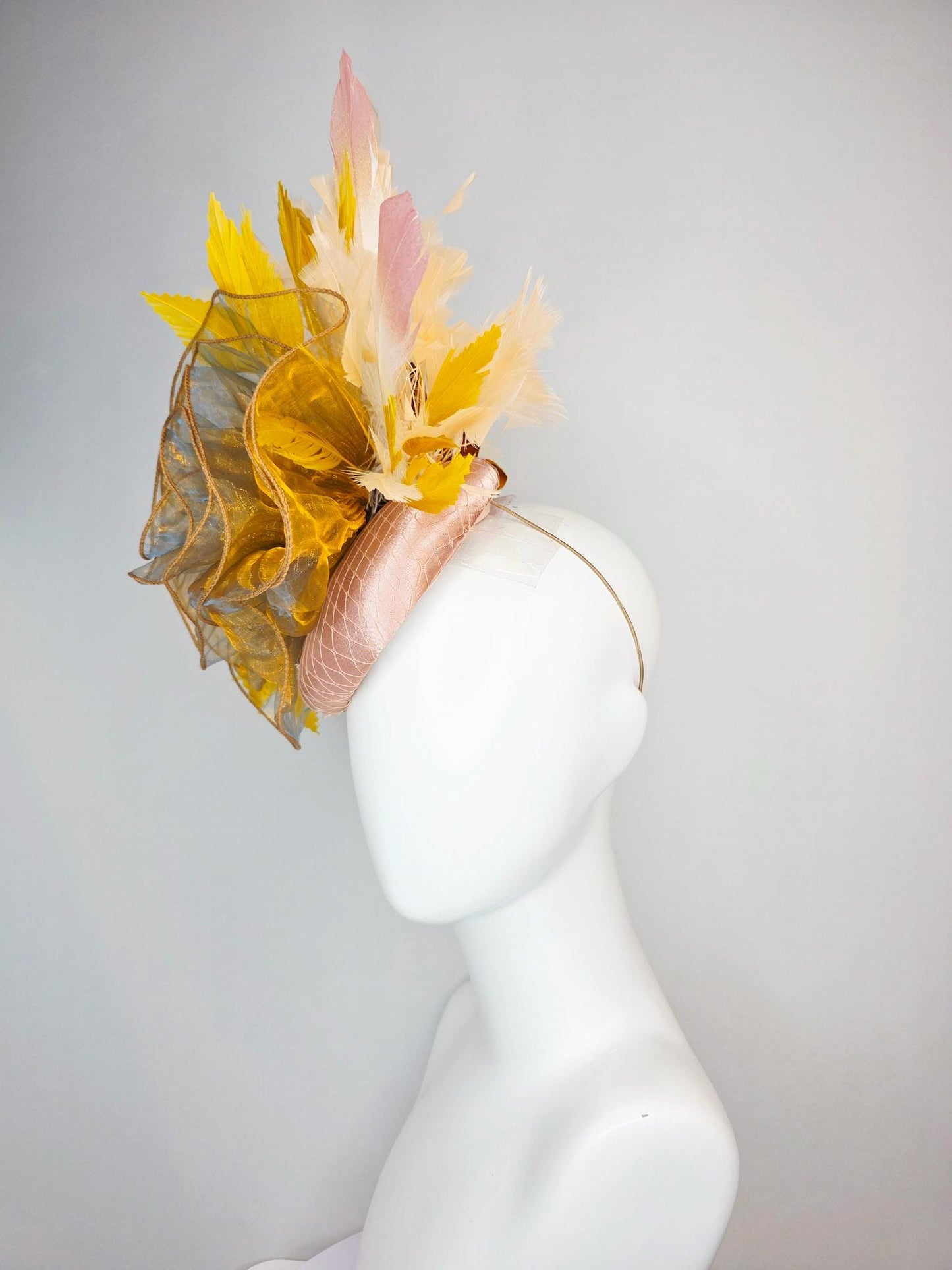 kentucky derby hat fascinator champagne pink satin with netting with large gold organza flower and mustard yellow cream beige feathers