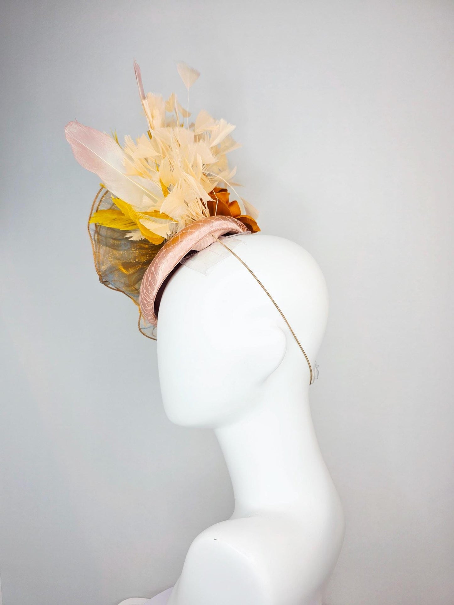 kentucky derby hat fascinator champagne pink satin with netting with large gold organza flower and mustard yellow cream beige feathers