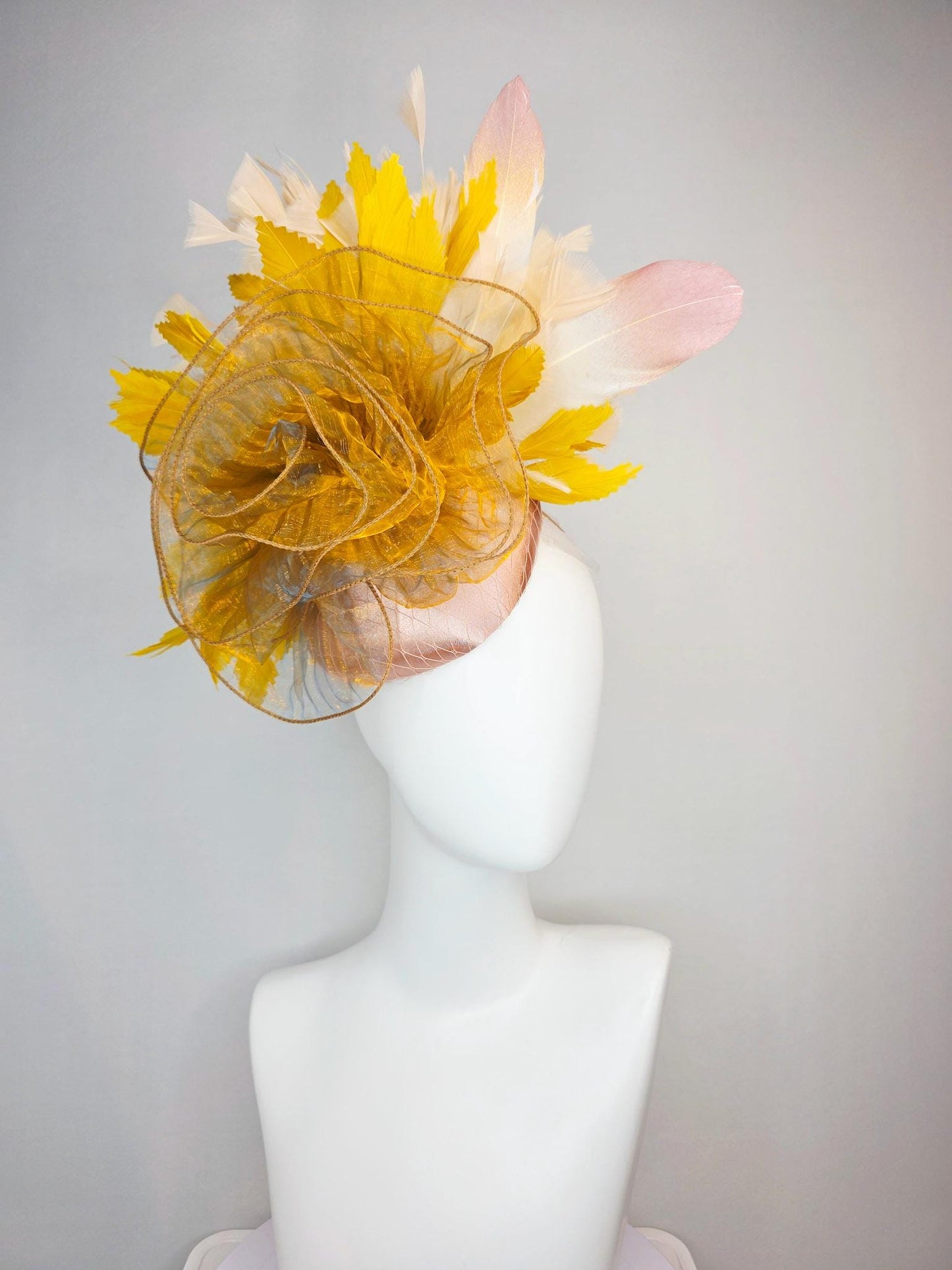 kentucky derby hat fascinator champagne pink satin with netting with large gold organza flower and mustard yellow cream beige feathers