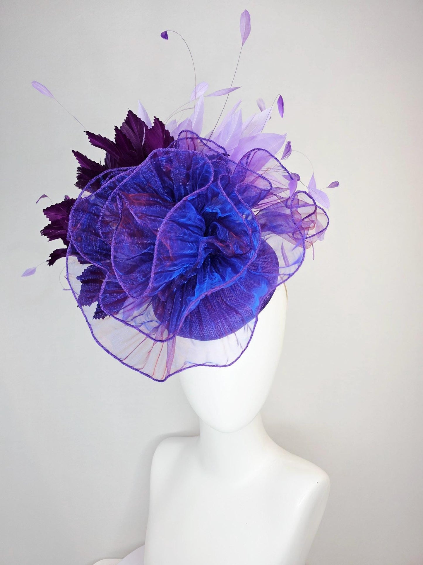 kentucky derby hat fascinator purple sinamay with large purple blue organza flower lavender and violet purple branching feathers