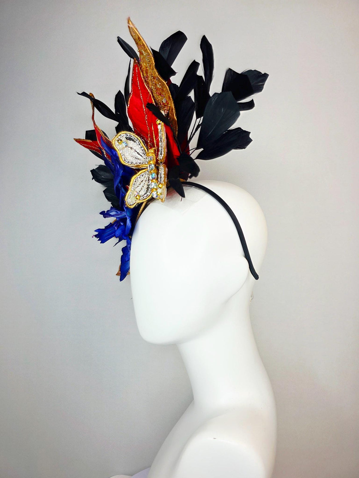 kentucky derby hat fascinator large royal blue satin flower red and gold organza satin leaves black branching feathers gold pearl butterfly