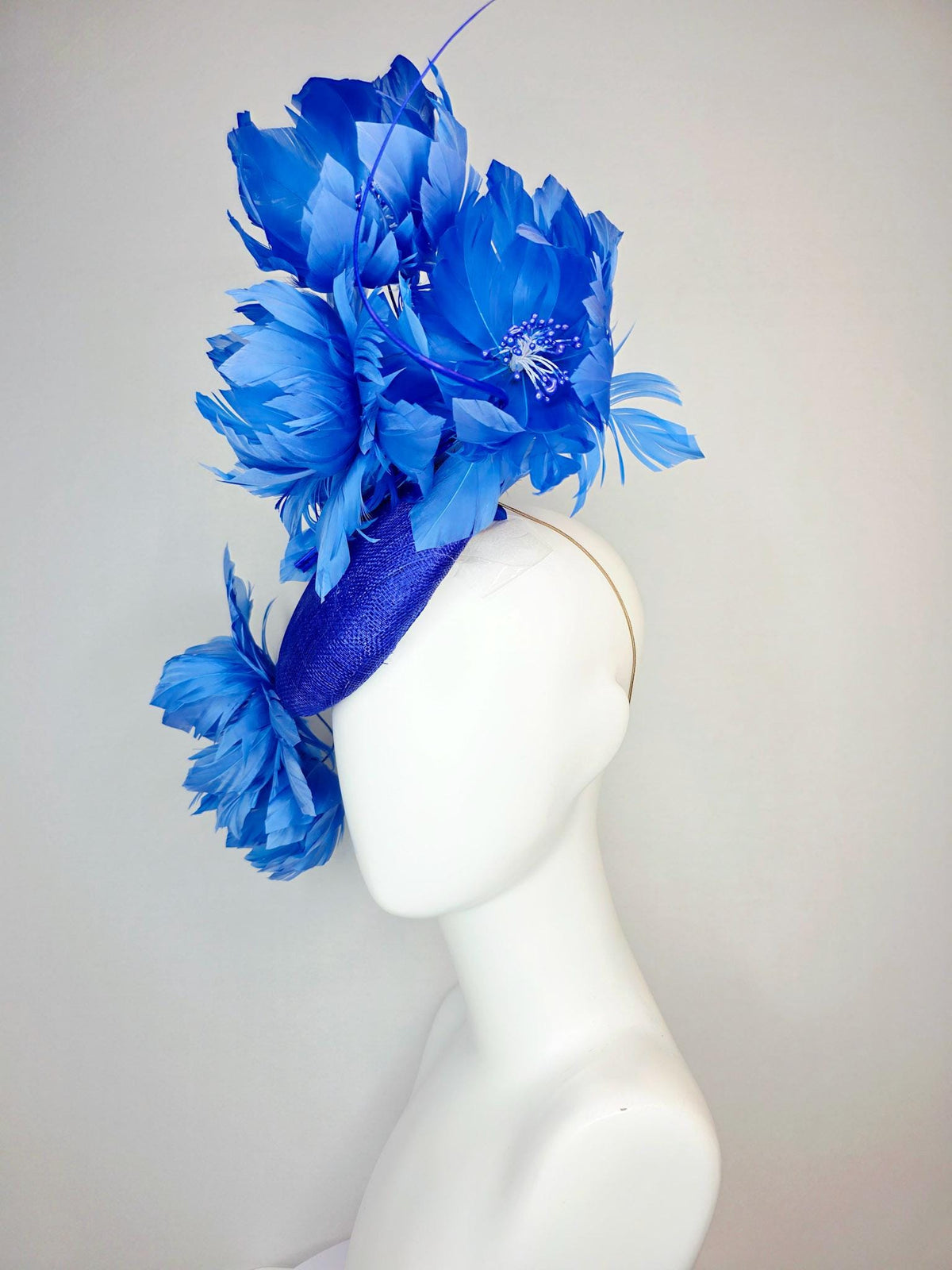 kentucky derby hat fascinator royal blue sinamay with large fluffy cobalt blue feather flowers and sky blue feathers