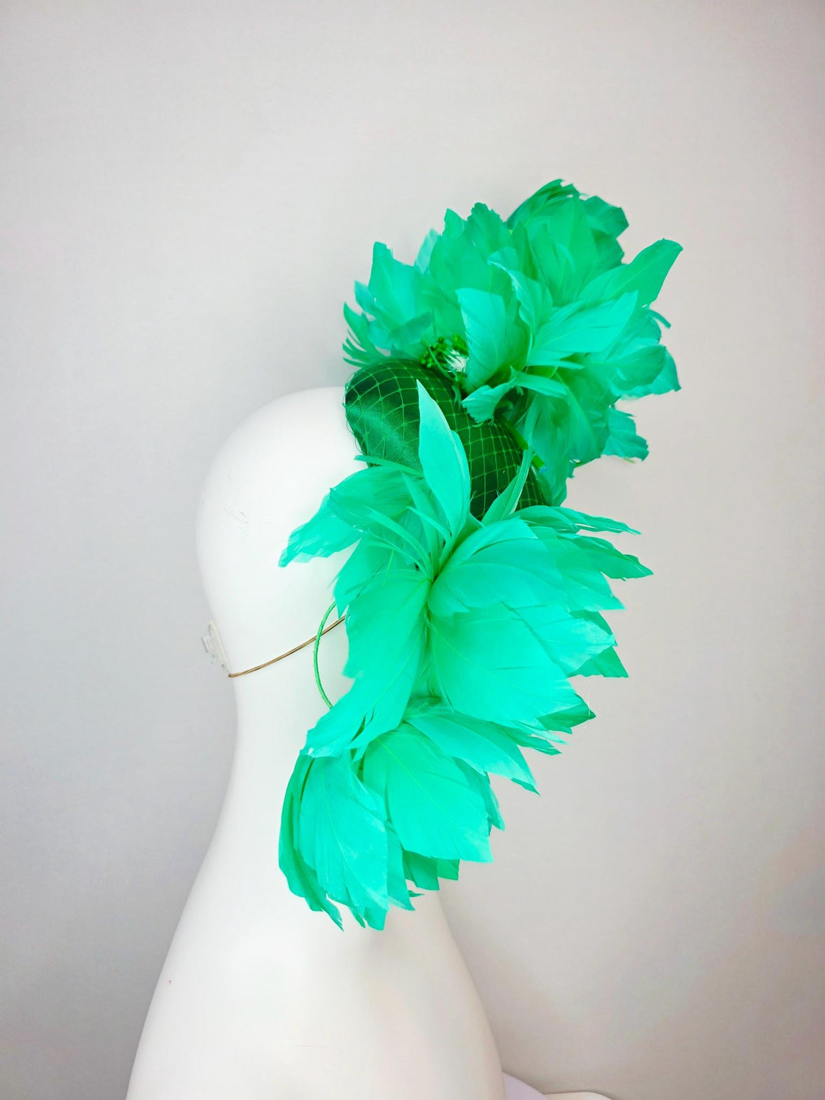 kentucky derby hat fascinator emerald green satin with netting and large fluffy green feather flowers and green feathers
