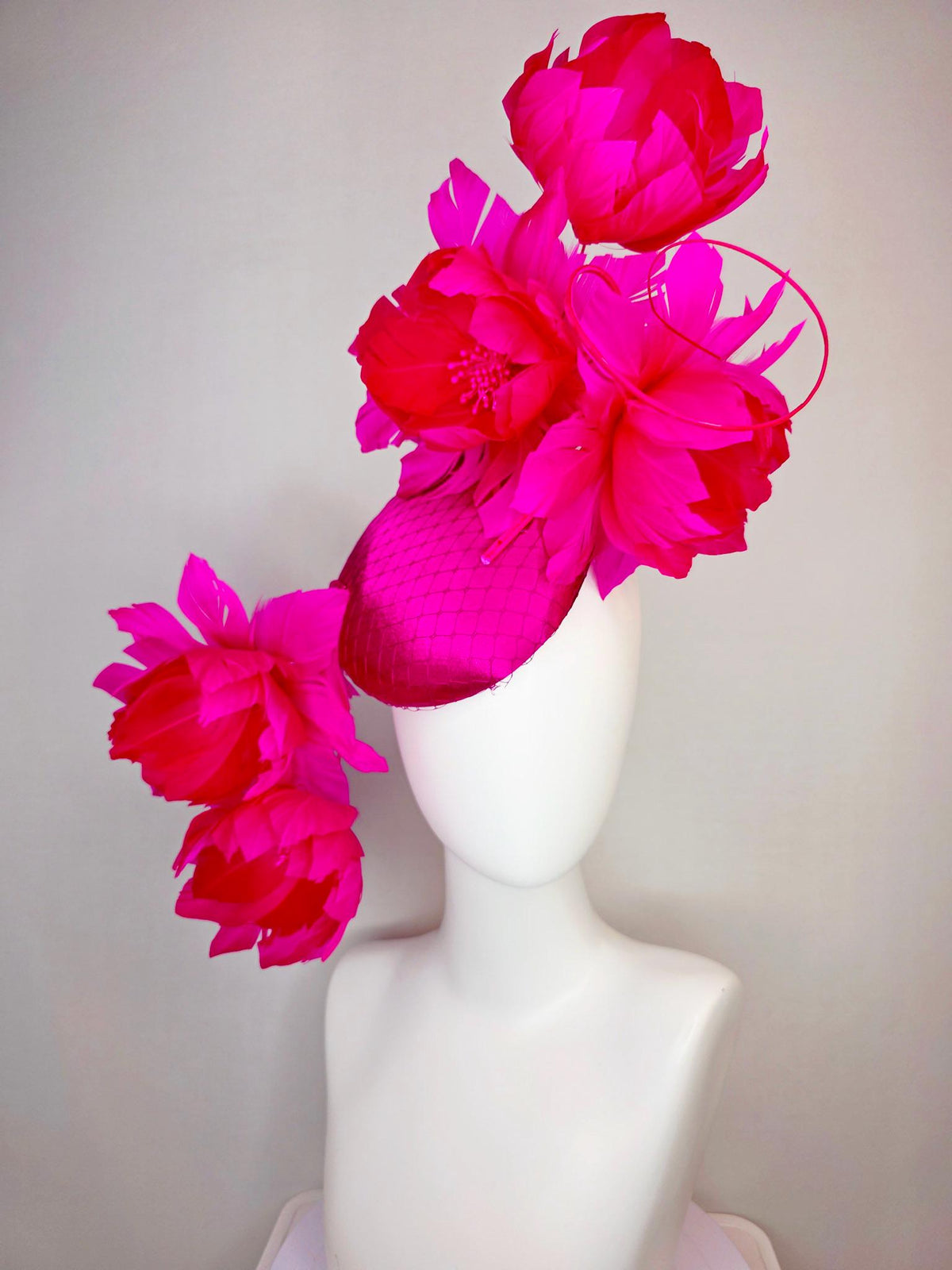 kentucky derby hat fascinator hot pink satin with netting and large fluffy hot red feather flowers with bright fuchsia pink feathers