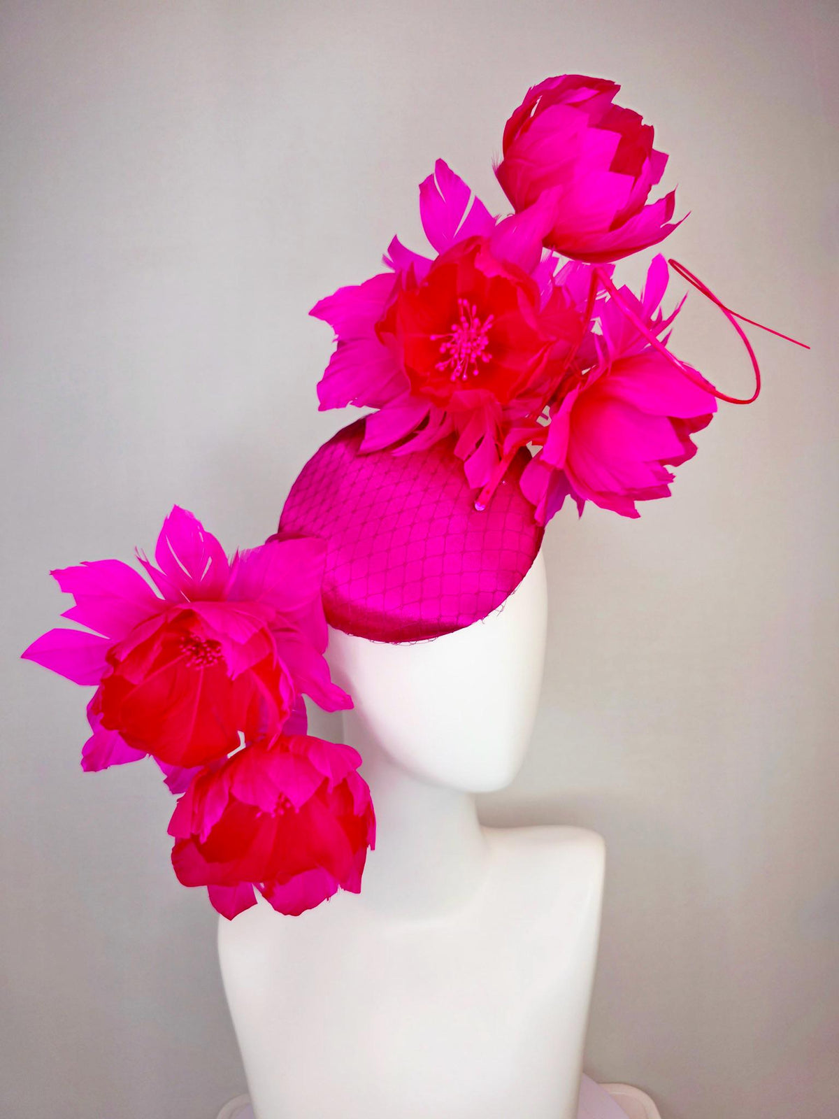kentucky derby hat fascinator hot pink satin with netting and large fluffy hot red feather flowers with bright fuchsia pink feathers