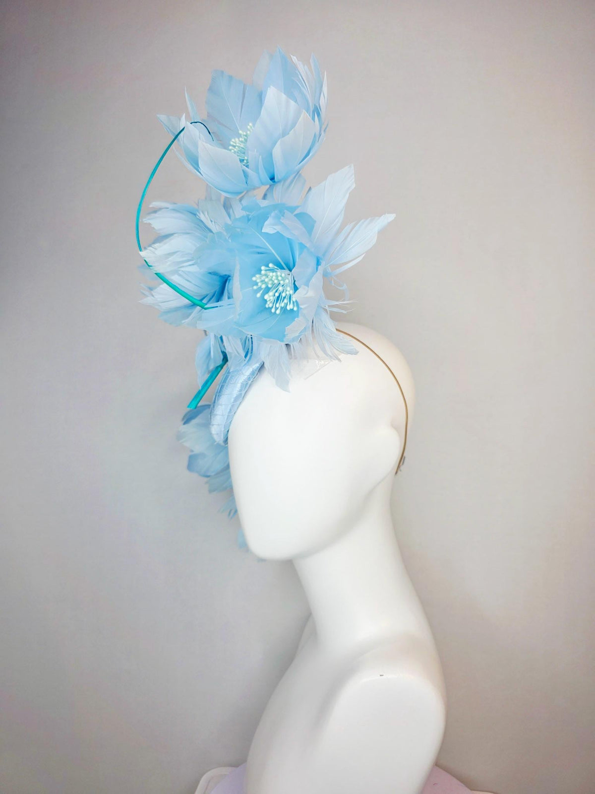 kentucky derby hat fascinator light blue satin with netting and large fluffy sky blue feather flowers and baby blue feathers