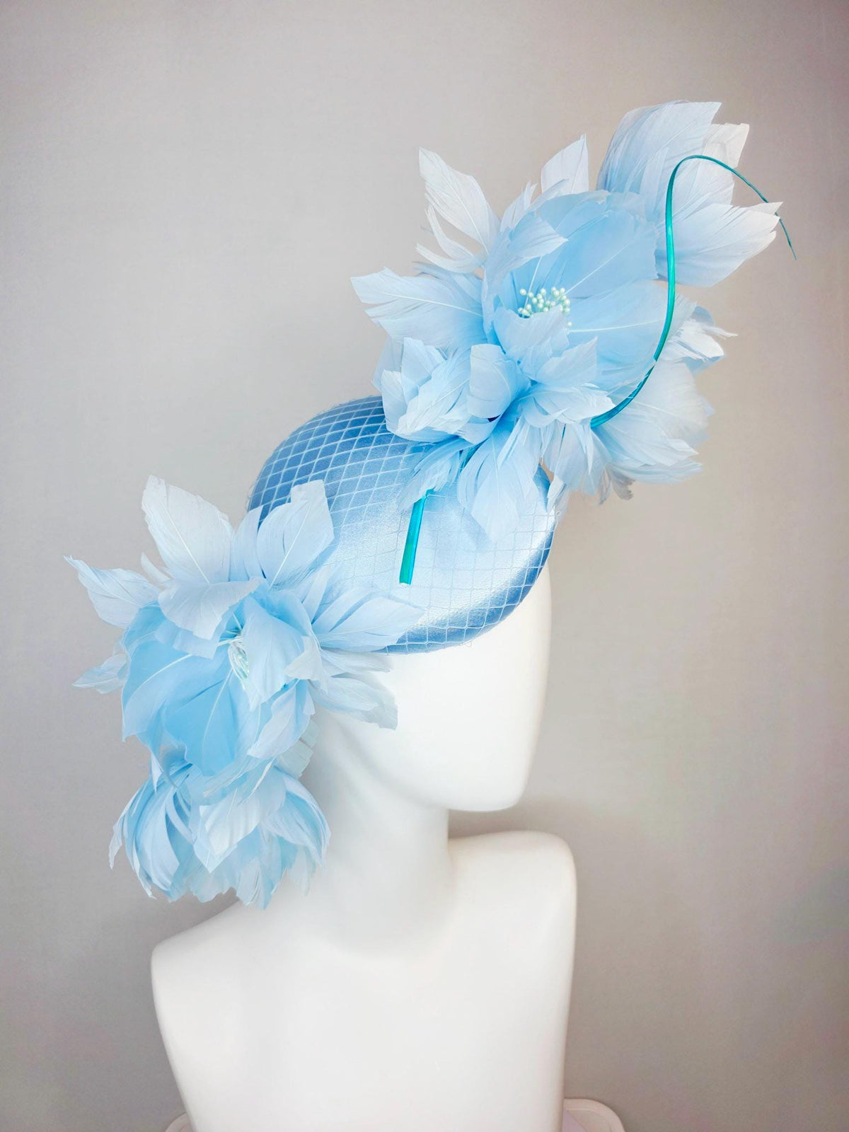 kentucky derby hat fascinator light blue satin with netting and large fluffy sky blue feather flowers and baby blue feathers