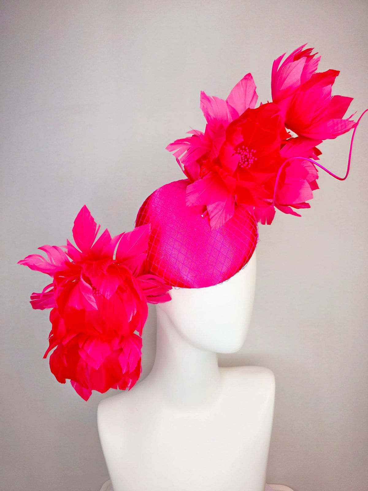 kentucky derby hat fascinator hot raspberry pink satin with netting and large fluffy red feather flowers with fuchsia pink feathers