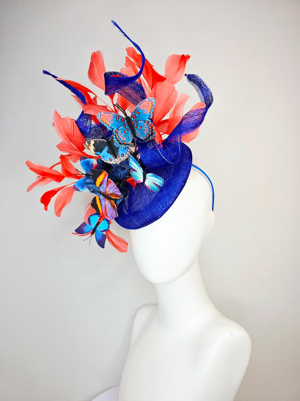 kentucky derby hat fascinator cobalt blue sinamay with curls royal blue organza flower coral orange feathers blue yellow black butterflies