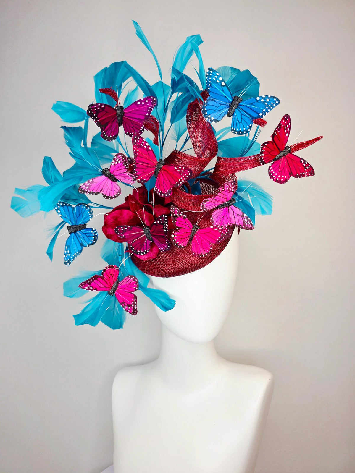 kentucky derby hat fascinator burgundy red sinamay with curls wine red organza flower turquoise sky blue feathers blue pink red butterflies