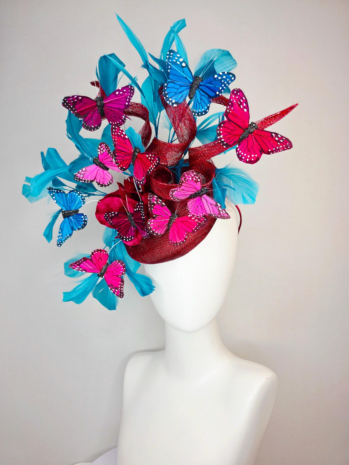 kentucky derby hat fascinator burgundy red sinamay with curls wine red organza flower turquoise sky blue feathers blue pink red butterflies