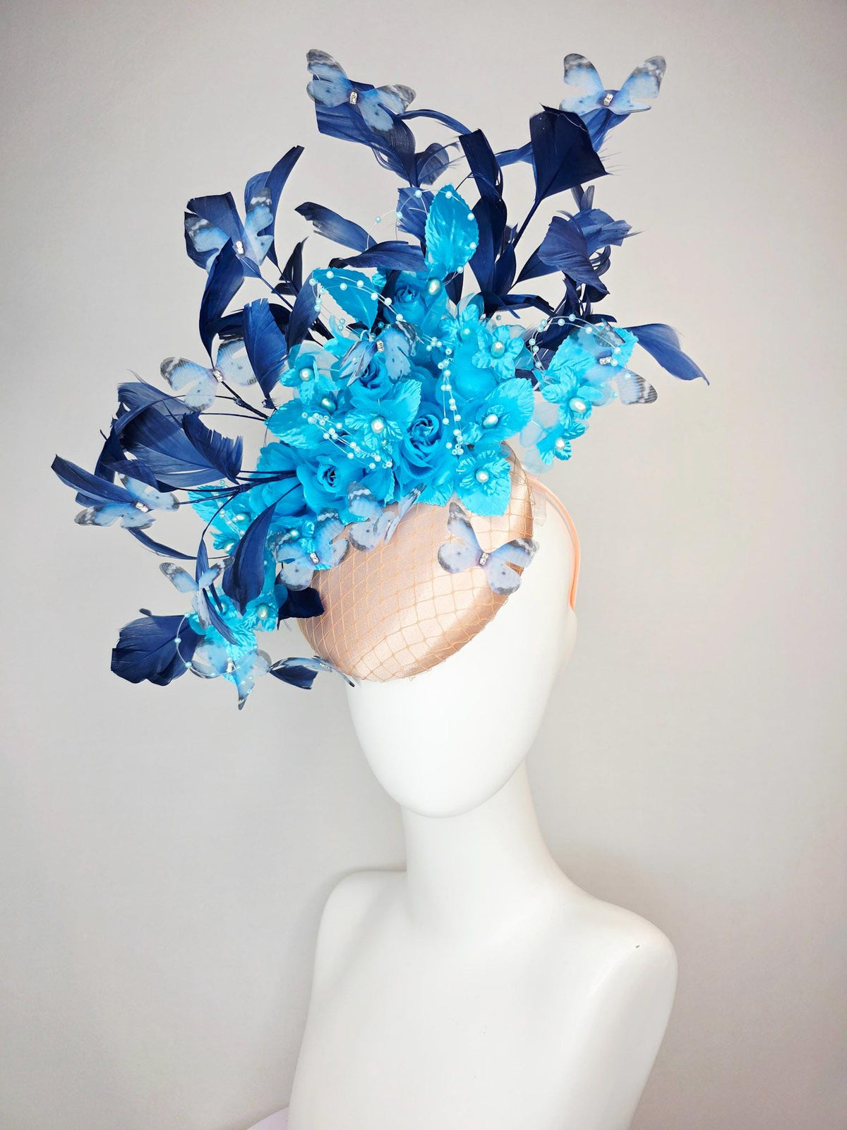 kentucky derby hat fascinator beige satin with netting ocean blue organza roses sky blue satin flowers navy blue feathers blue butterflies