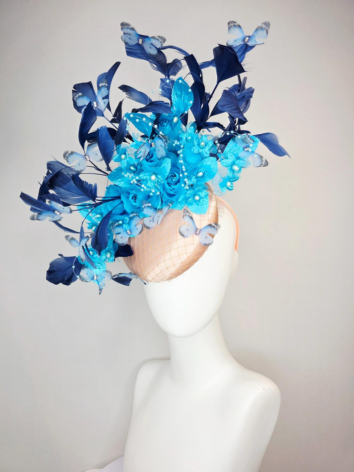 kentucky derby hat fascinator beige satin with netting ocean blue organza roses sky blue satin flowers navy blue feathers blue butterflies