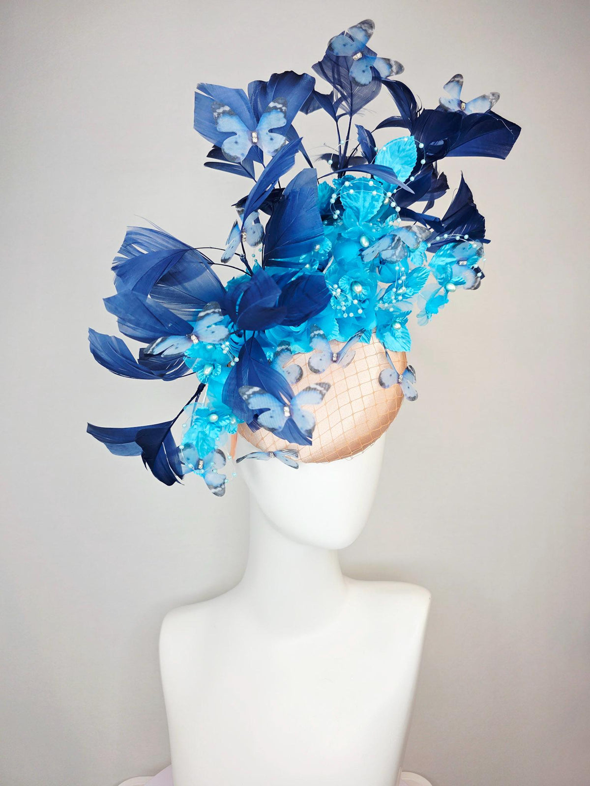 kentucky derby hat fascinator beige satin with netting ocean blue organza roses sky blue satin flowers navy blue feathers blue butterflies