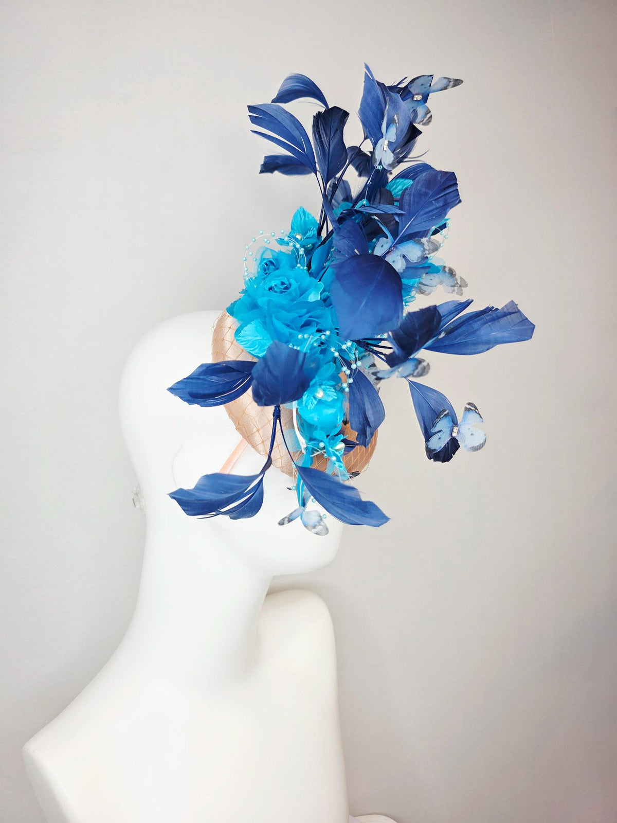 kentucky derby hat fascinator beige satin with netting ocean blue organza roses sky blue satin flowers navy blue feathers blue butterflies