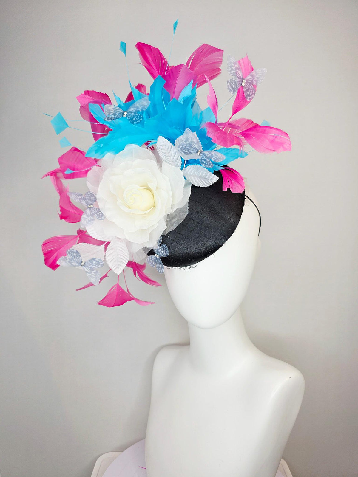 kentucky derby hat fascinator black satin with netting ivory white organza rose white leaves pink sky blue feathers light gray butterflies