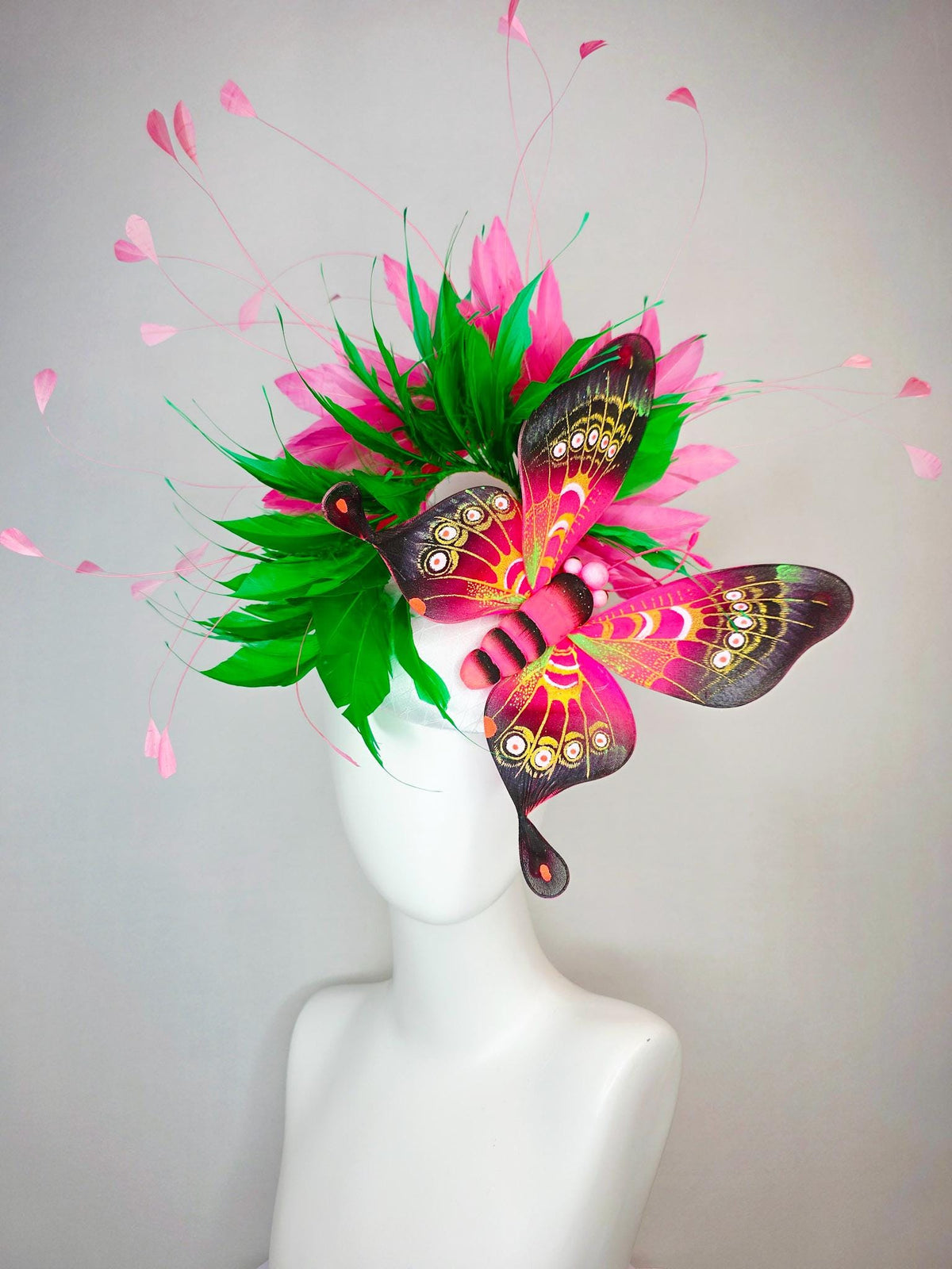 kentucky derby hat fascinator white satin with netting emerald green and hot pink branching feathers with large pink yellow black butterfly