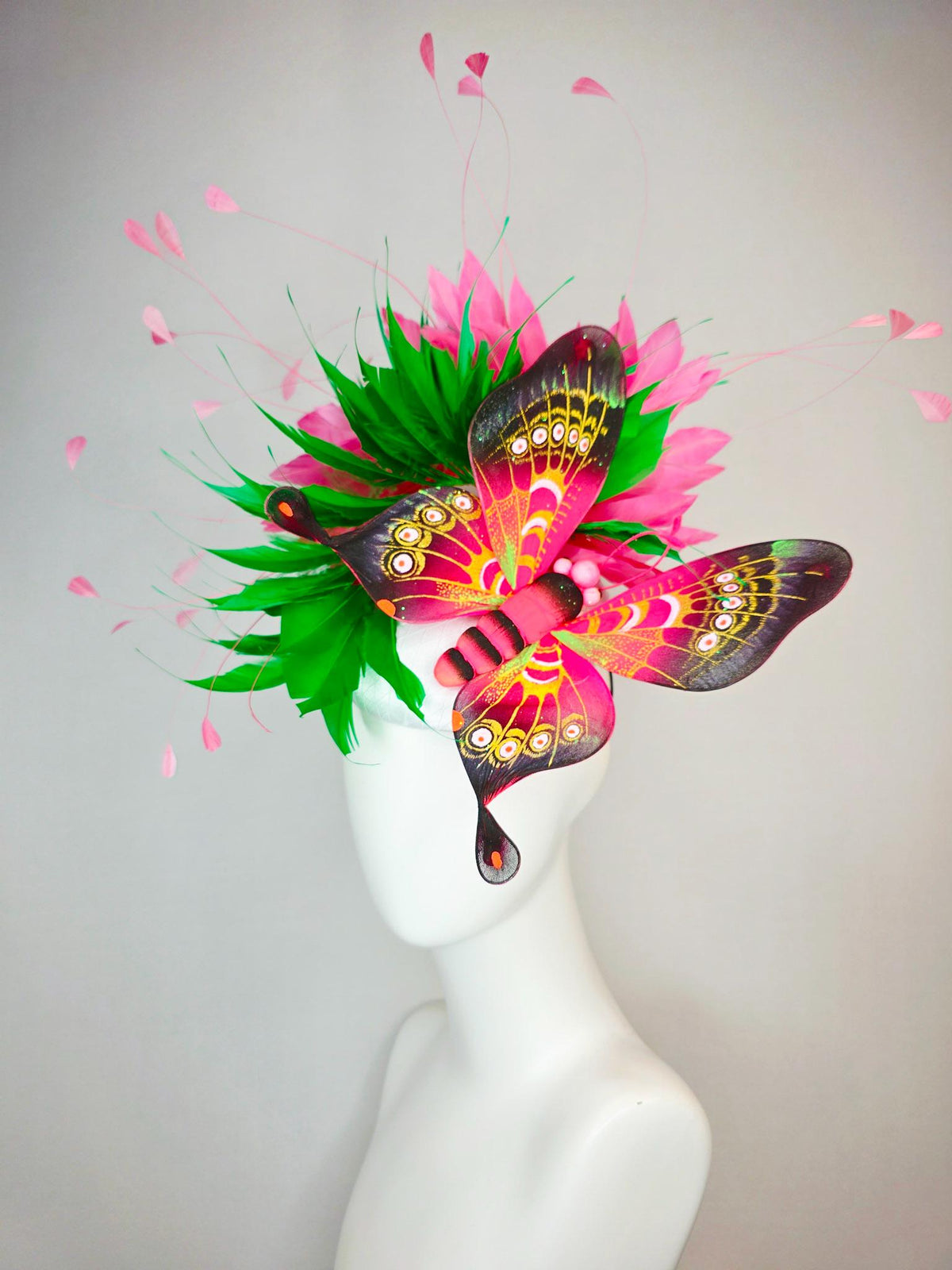 kentucky derby hat fascinator white satin with netting emerald green and hot pink branching feathers with large pink yellow black butterfly