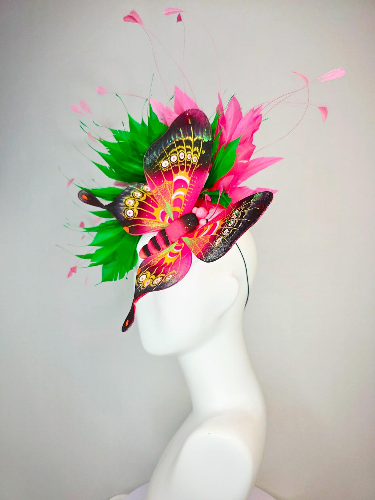 kentucky derby hat fascinator white satin with netting emerald green and hot pink branching feathers with large pink yellow black butterfly