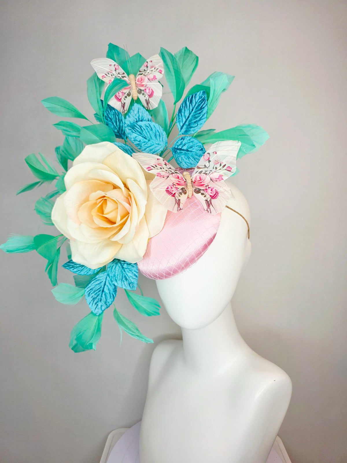 kentucky derby hat fascinator light pink satin with netting ivory cream satin rose turquoise blue leaves mint green feathers and butterflies